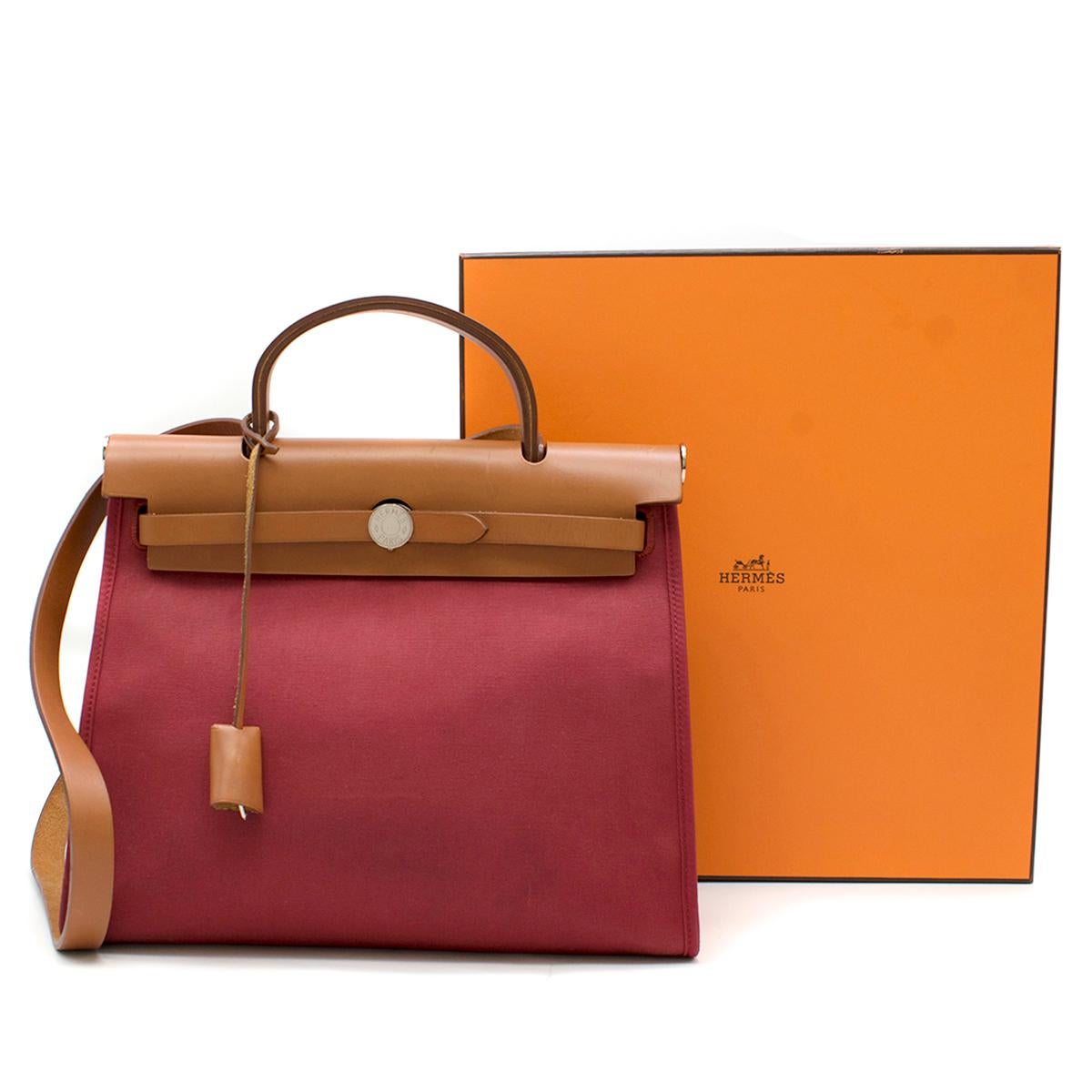 Hermes Rouge Garance Canvas & Leather Herbag Zip PM Bag

- Date Stamp N in a square (Circa 2010)
- Rouge Garance
- Canvas 
- Caramel-tone calfskin leather round top handle and shoulder strap
- Foldover leather top
- Signature palladium plated