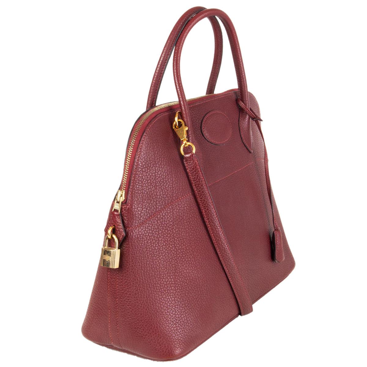 100% authentic Hermes 'Bolide 35' bag in Rouge H (burgundy) Vache Fjord leather (grained) with gold-plated hardware. Lined in Roughe H lamb skin leather with an open pocket against the back. Has been carried and is in excellent condition. Comes with