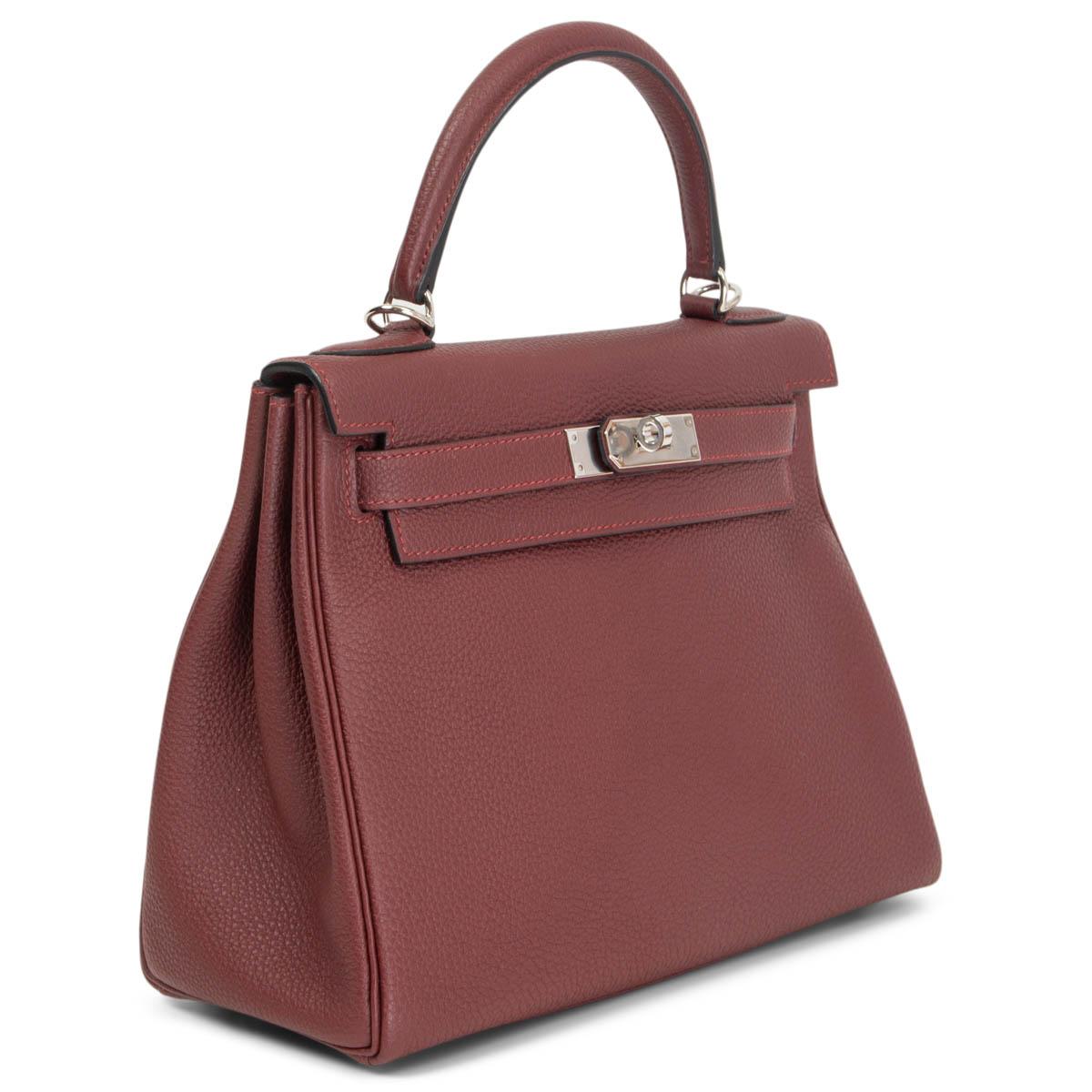 100% authentic Hermès Kelly ll 28 Retourne in Rouge H Togo leather with palladium hardware. Lined in Rouge H goat skin leather with two open pockets against the front and a zipper pocket against the back. Brand new. Comes with shoulder strap, lock,