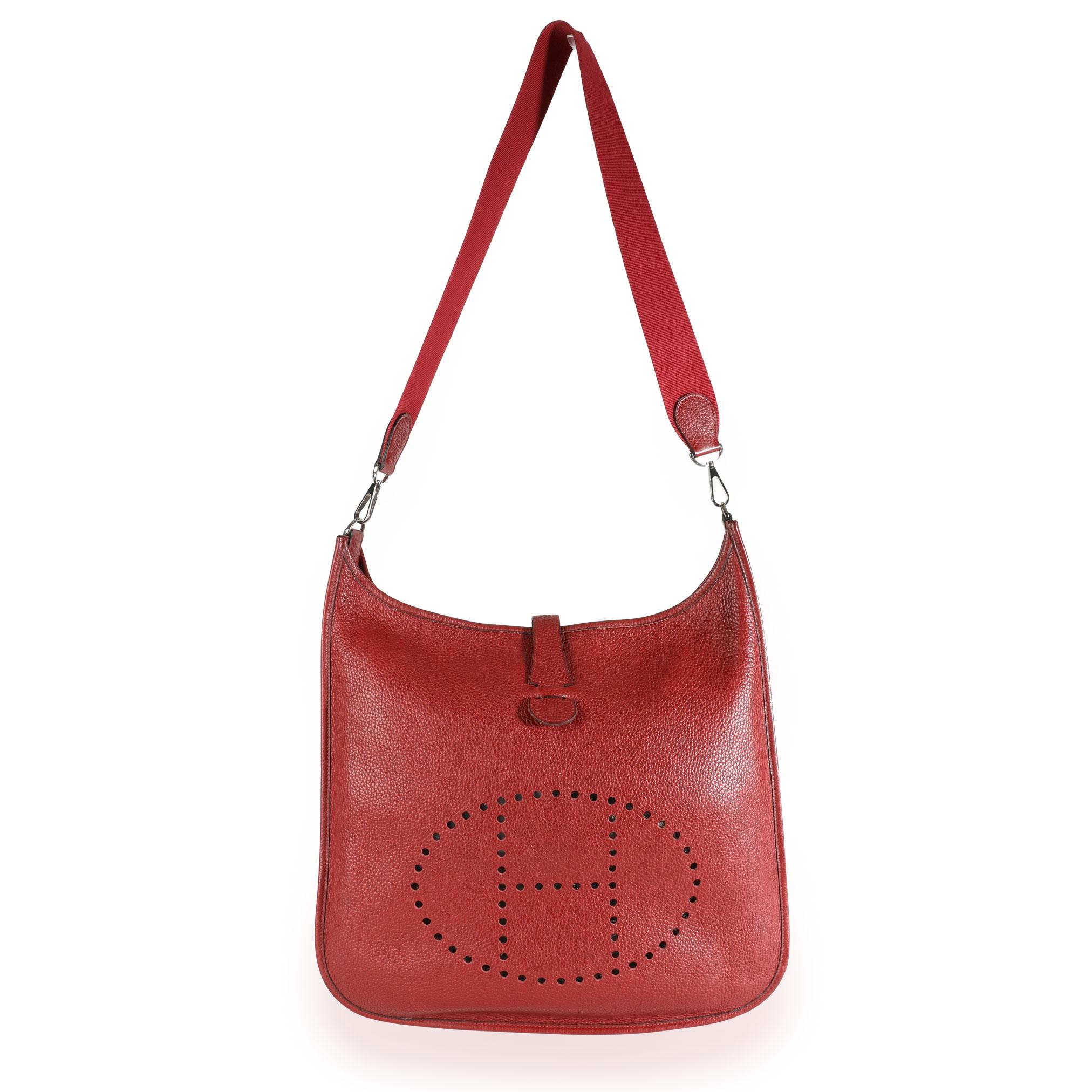 Listing Title: Hermès Rouge H Clémence Evelyne II TGM PHW
SKU: 111317
Condition: Pre-owned (3000)
Handbag Condition: Good
Condition Comments: Good Condition. Faint discoloration throughout leather. Discoloration to strap. Wear to leather piping.