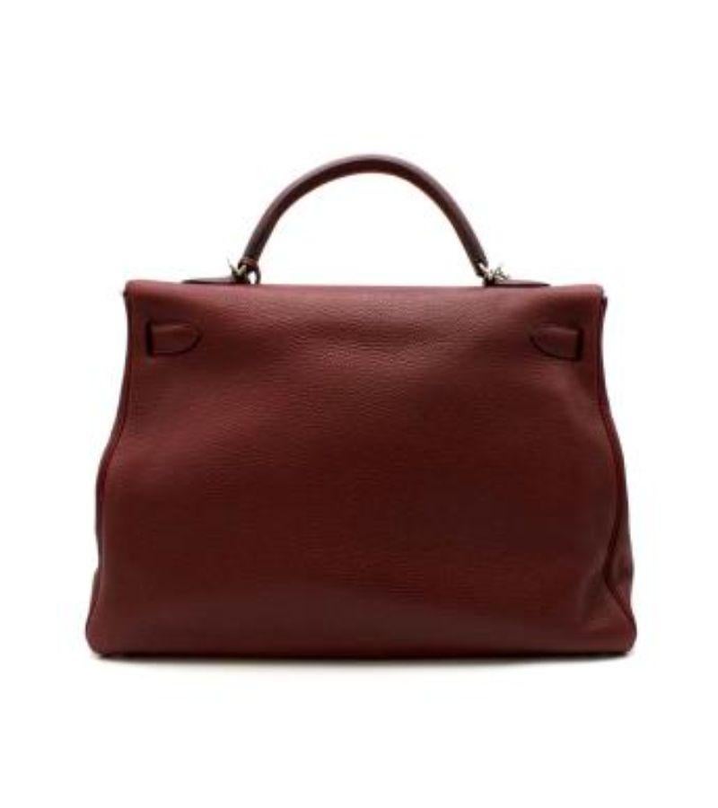 Hermes Rouge H Clemence Leather Kelly Retourne 40 PHW

- Rare discontinued size
- Pebbled burgundy leather with palladium plated hardware 
- Detachable woven cotton pink and burgundy shoulder strap
- Single top handle 
- Flat on the bottom with 4