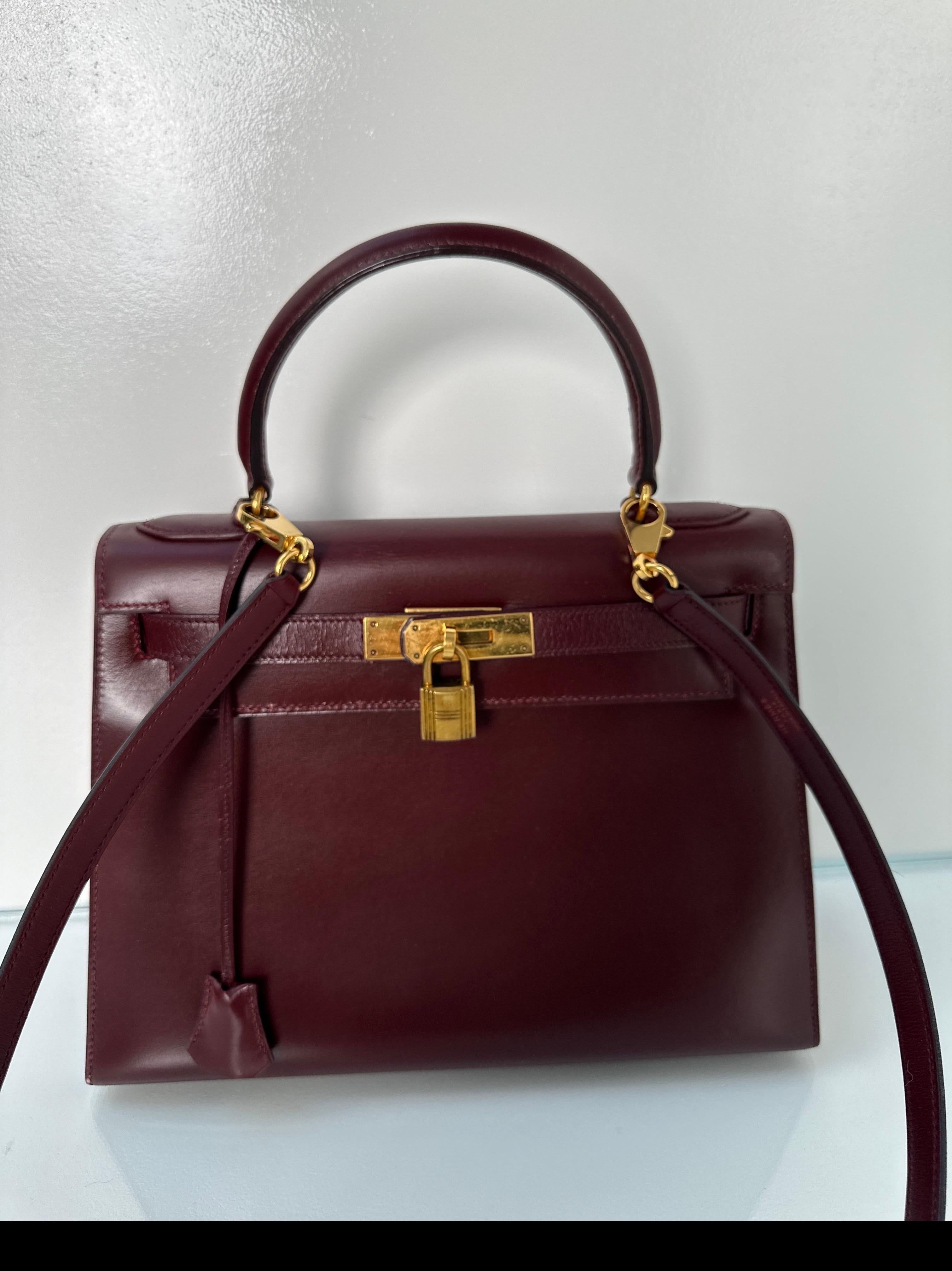 Hermes Rouge H Kelly Bag. Beautiful vintage box leather. Gold hardware. Vintage so has some wear on the front straps from age. Beautiful leather. Wear on hardware from age. Interior clean. Includes clochette, lock, keys, and dust bag. Guaranteed