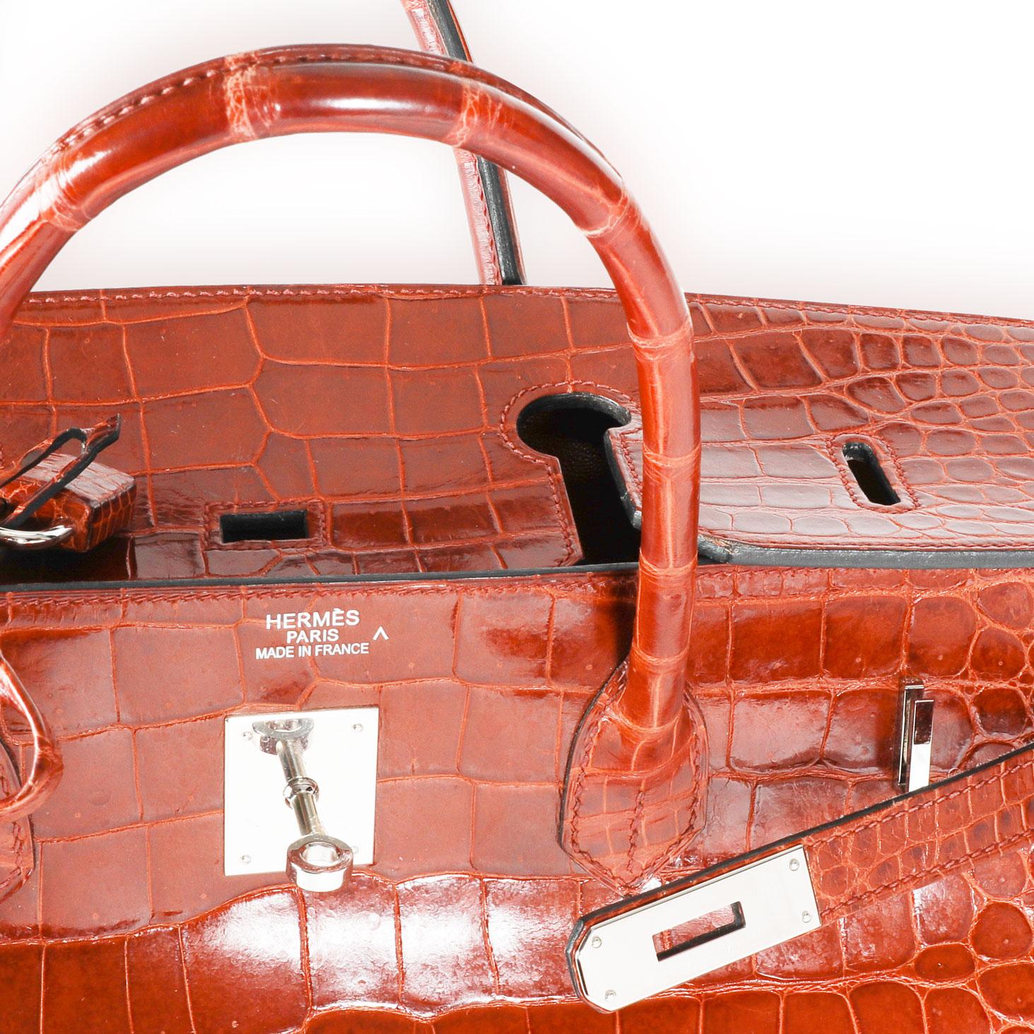Hermès Rouge H Shiny Porosus Crocodile Birkin 40 PHW
SKU: 112665
Very Good Condition. Scuffing to corners. Cracking to handles. Scratching and tarnishing to hardware. Marks to interior. Please note: this item can not be shipped to all areas.

Brand: