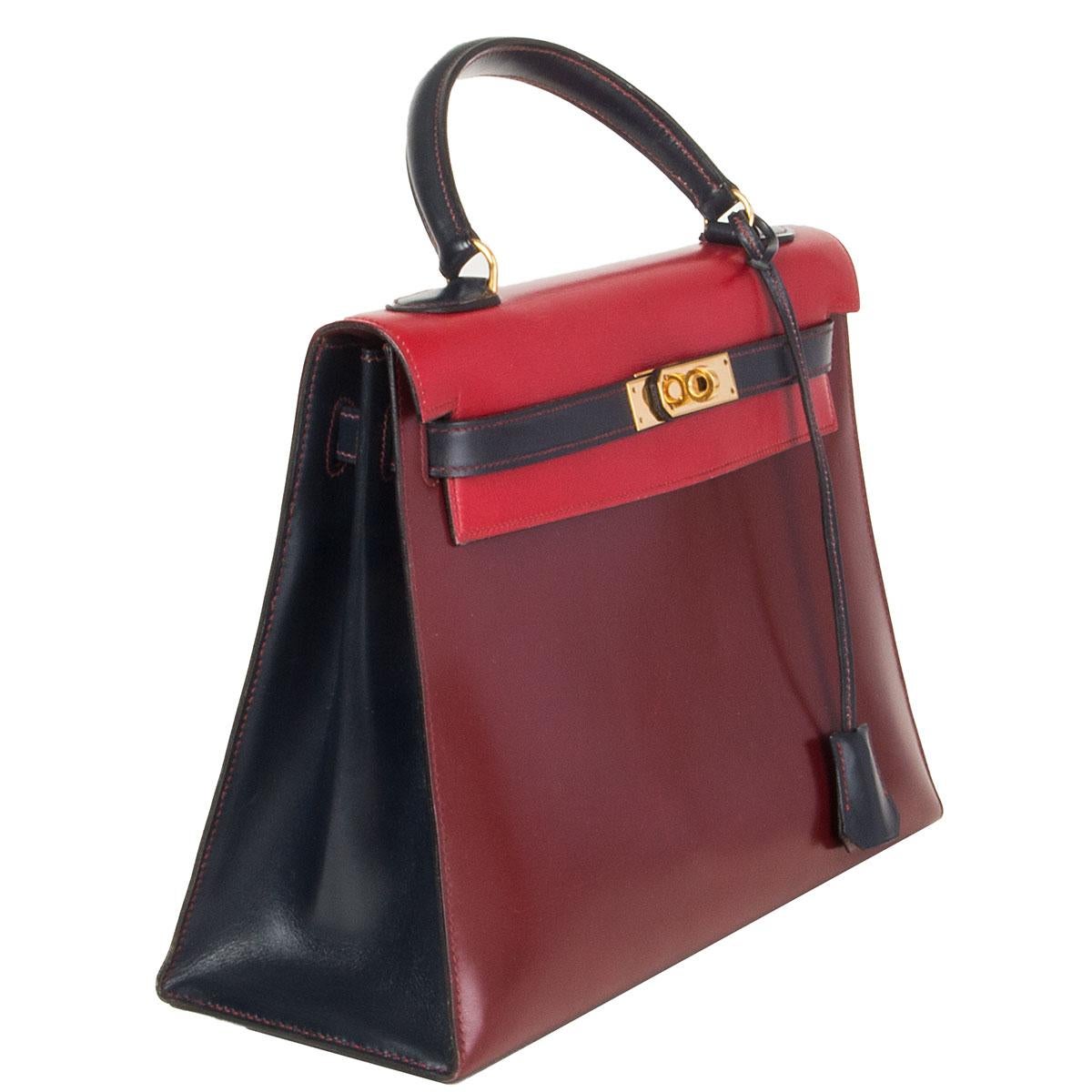 100% authentic Hermès 'Kelly I 32 Sellier' bag in Rouge H (burgundy), Rouge Vif (red) and Bleu Marine (navy blue) Veau Box leather with gold-plated hardware. Vintage 1983. Lined in Rouge H Chevre (goat skin) with two open pockets against the front