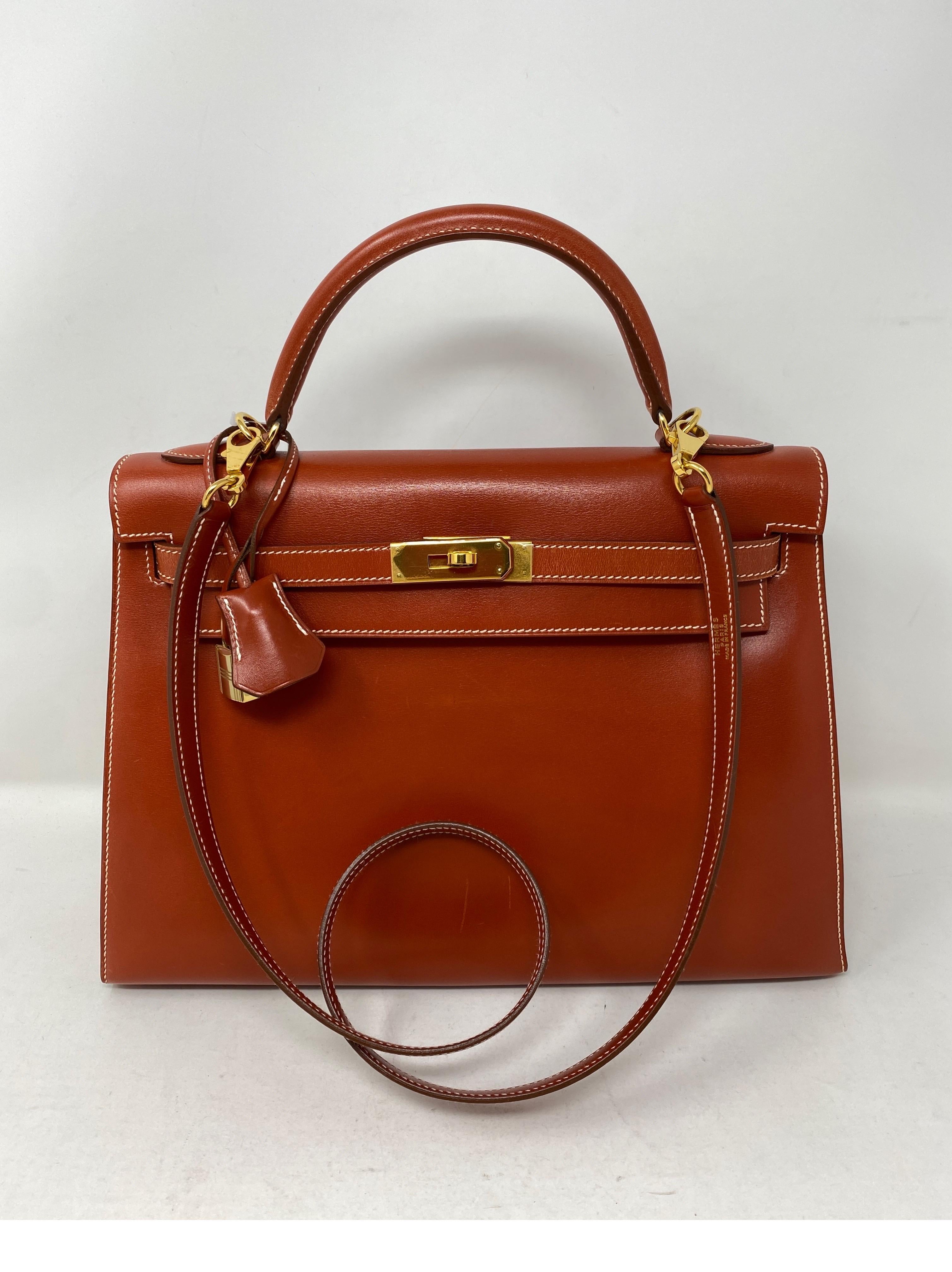 Hermes Rouge Kelly 35 Tadelakt leather. Griss interior. Light grey color interior. White contrast stitching. Beautiful vintage Kelly bag. Collector's piece. Light scratches on front of bag. Sellier shape bag. No slouch at all. A stunner. Rare combo.