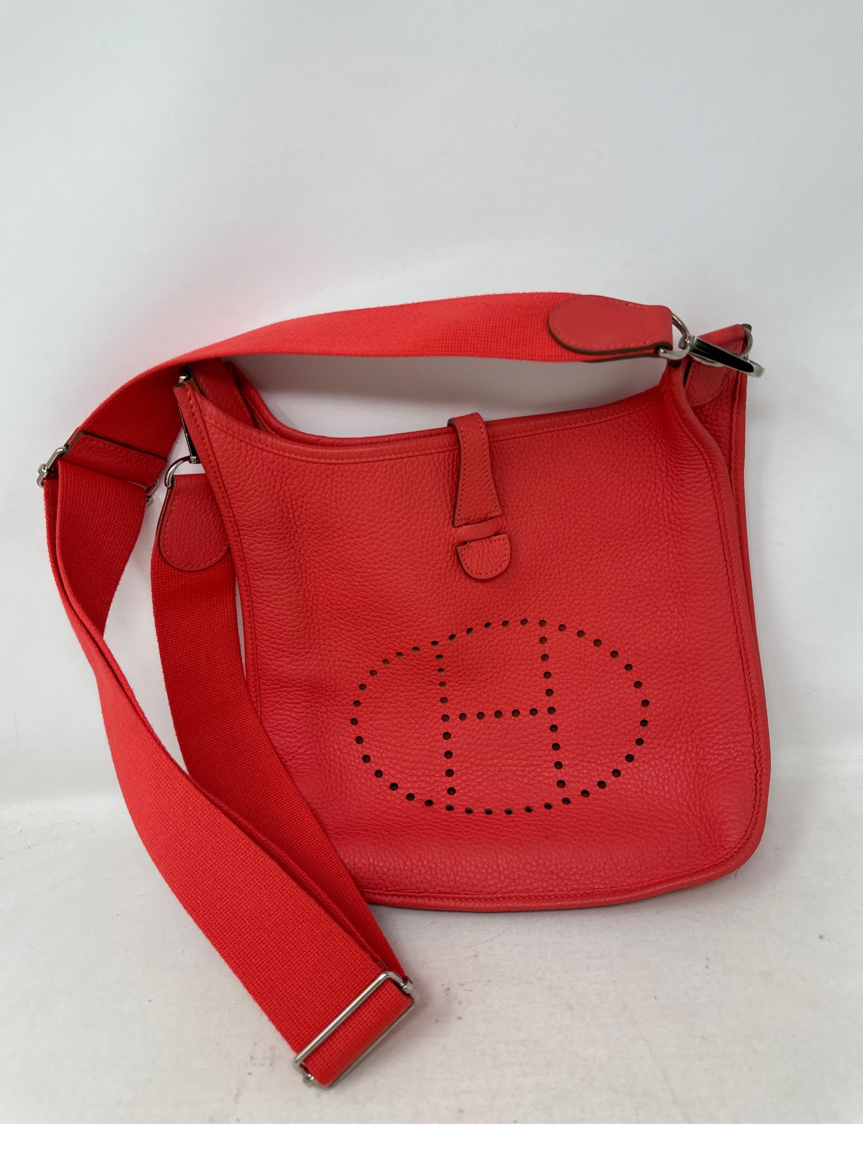 Hermes Rouge Pivoine Evelyne PM Bag. Excellent condition. Beautiful rosy pink/ coral salmon color. Clemence leather. Great crossbody bag. Has adjustable strap. Silver hardware. Interior clean. Includes dust bag. Guaranteed authentic. 