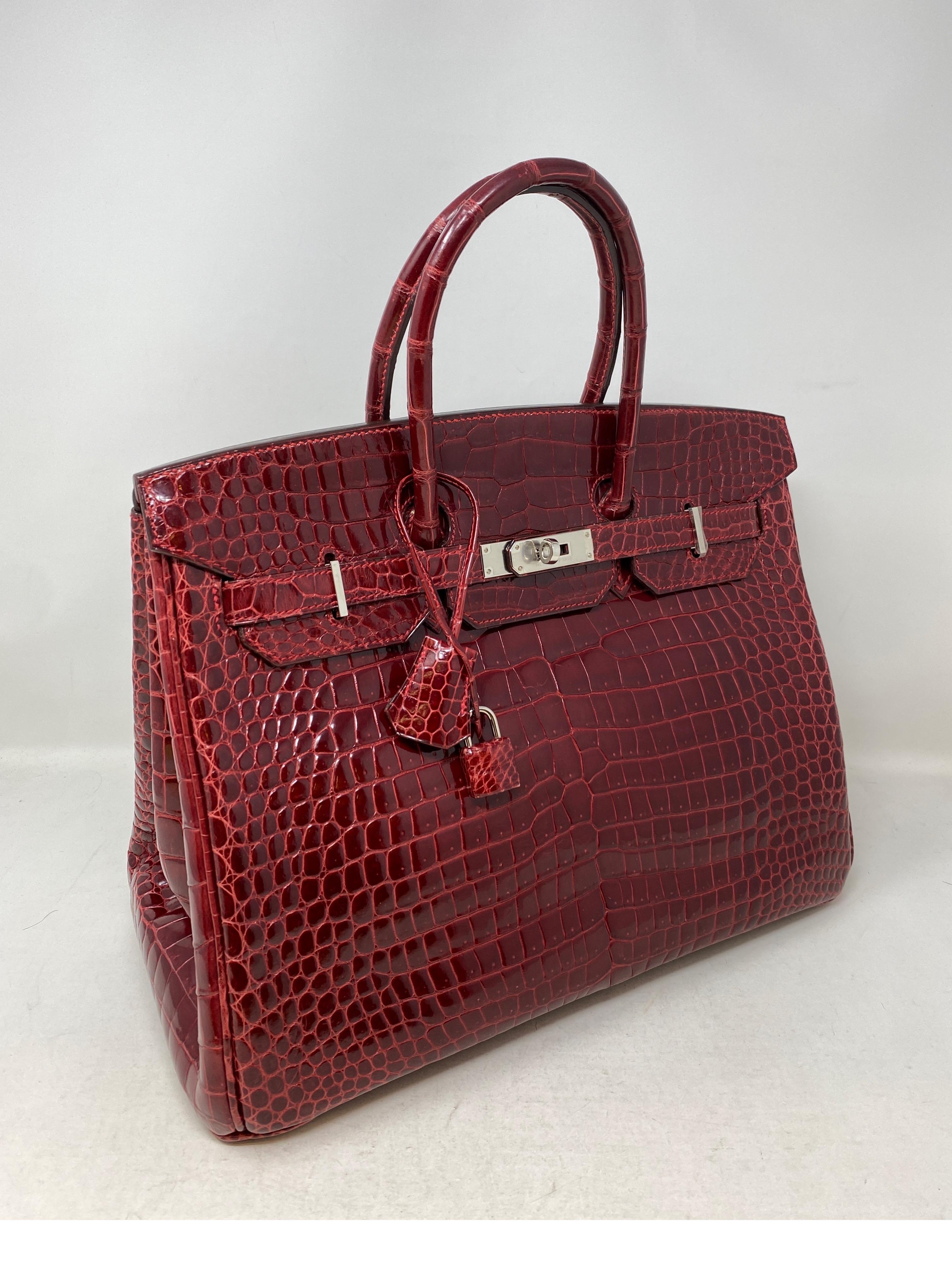 Hermes Rouge Shiny Porosus Crocodile Birkin 35 Bag. From 2011 O square stamp. Palladium hardware. Beautiful burgundy rouge color. Excellent condition. Stayed in the box. Porosus crocodile is the most luxurious exotic skin from Hermes. Created by