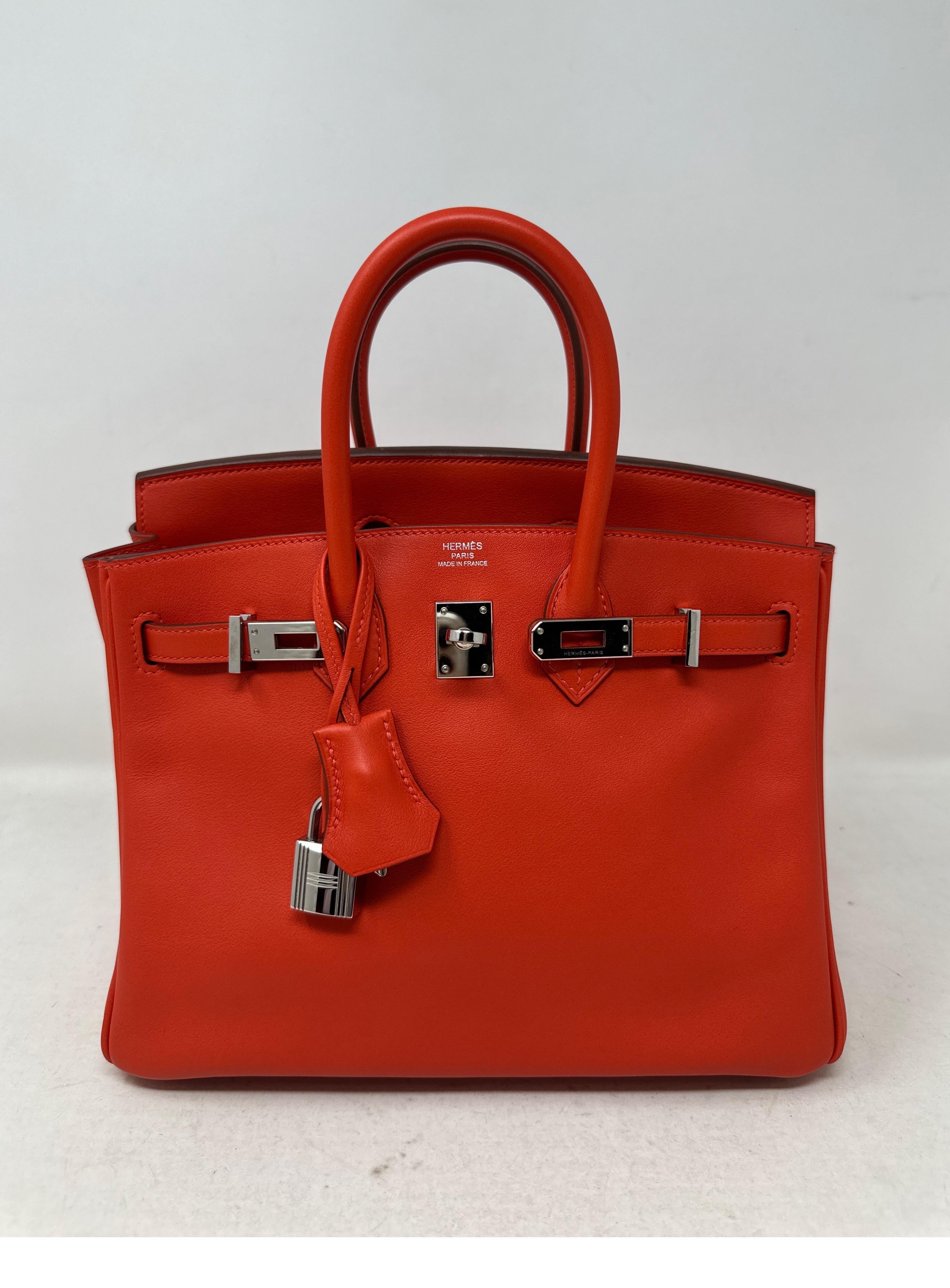 Hermes Rouge Tomate Birkin 25 Bag. Beautiful orange red color in smooth swift leather. Palladium silver hardware. Excellent condition. Interior clean. Includes clochette, lock, keys, and dust bag. Guaranteed authentic. 