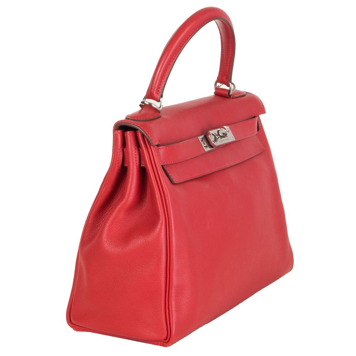 100% authentic Hermes 'Kelly 28 Retourne' bag in Rouge Tomate red Swift leather with palladium hardware. Lined in Chevre (goat skin) with an open pocket against the front and a zipper pocket against the back. Has been carried and is in excellent