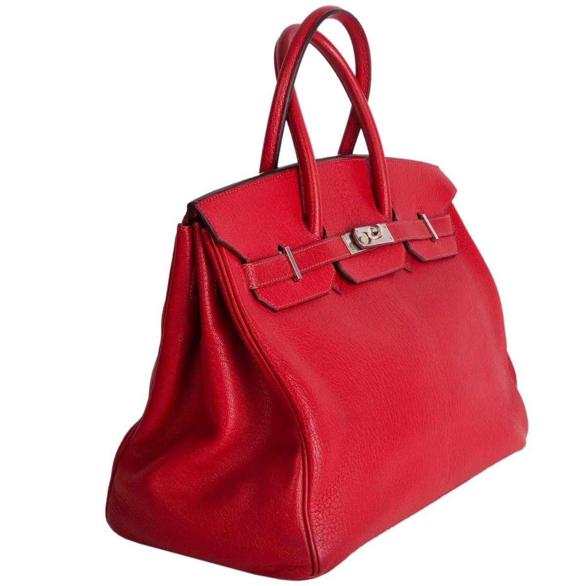 Hermes 'Birkin 35' bag in Rouge Vif (bright red) Chèvre Coromandel (goatskin) leather. Lined in Chèvre (goatskin) leather with an open pocket against the front and a zipper pocket against the back. Has been carried and the leather is cracked a