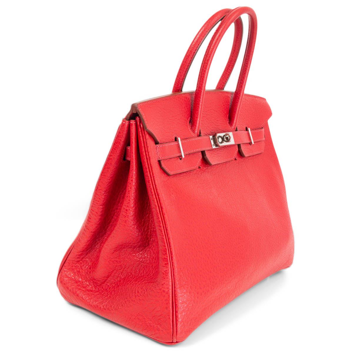 100% authentic Hermès 'Birkin 35' bag in Rouge Vif (true red) Skipper leather with palladium hardware. Lined in Chevre (goat skin) with an open pocket against the front and a zipper pocket against the back. Has been carried and and hardware shows