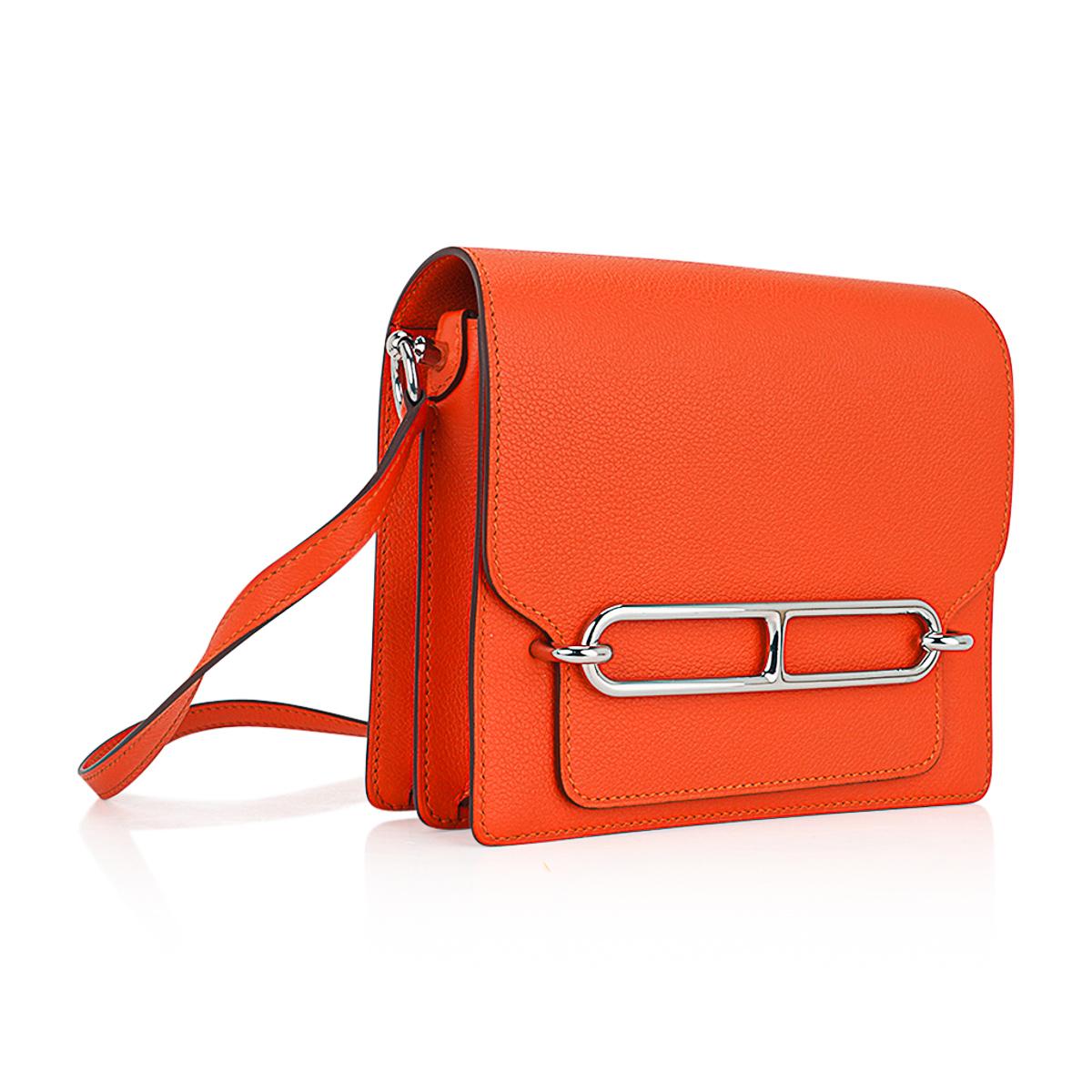 Mightychic offers an Hermes mini Roulis bag featured in Feu orange Evercolor leather.
Functional with interior compartments and a rear outer pocket.
The adjustable strap allows the bag to be carried as a crossbody or shoulder bag.
The square shape