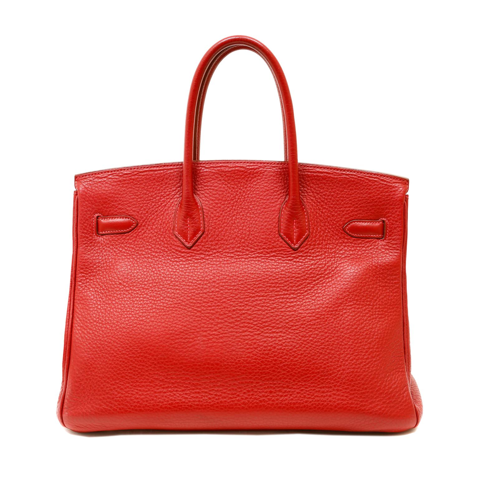 This authentic Hermès Rubis Red Togo 35 cm Birkin is in excellent condition.  A stunning lipstick red with pink undertones, Rubis is is perfectly paired with Palladium hardware.
Vivid red Togo leather is textured and soft to the hand with a