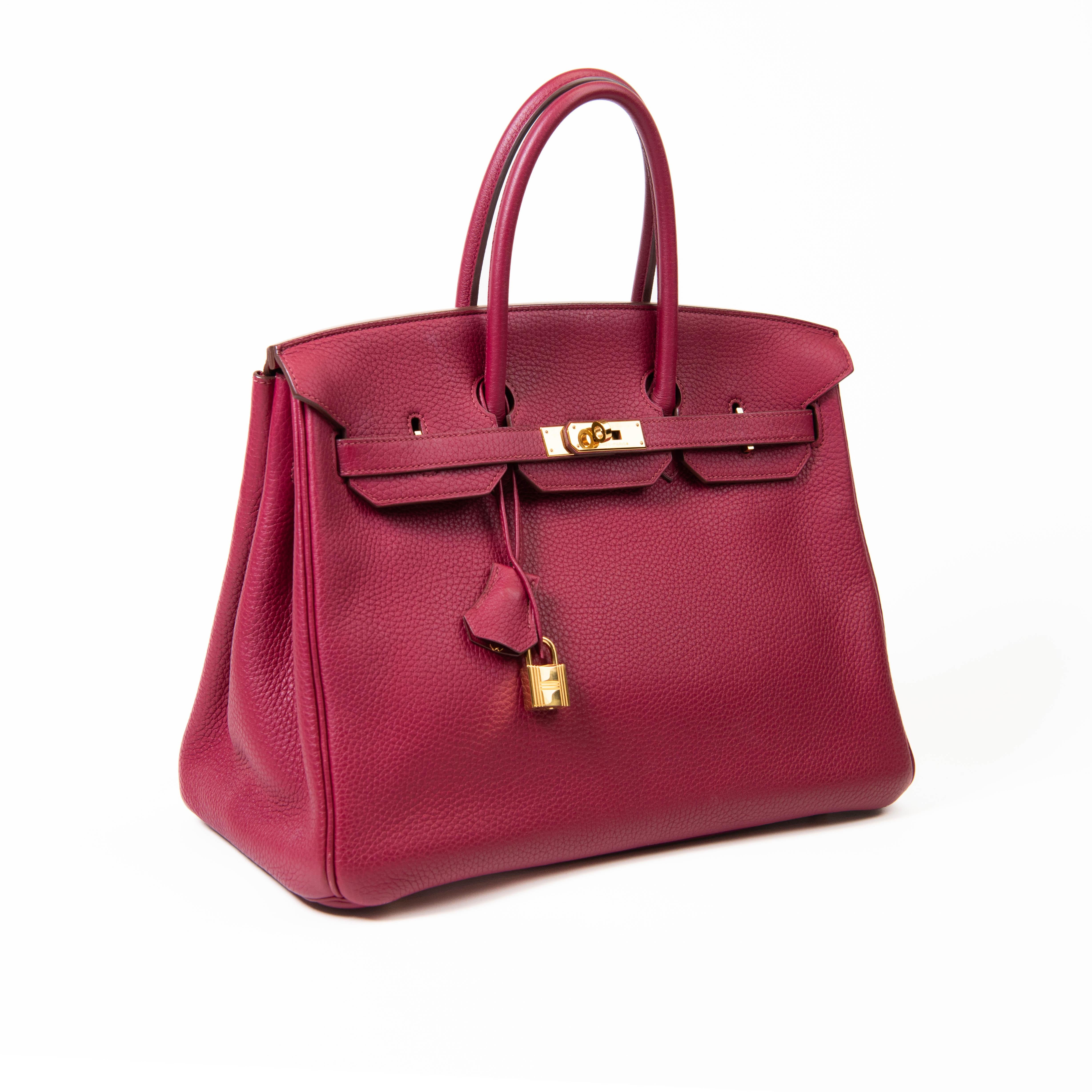 100% Authentic

This stylish tote is beautifully crafted of textured Togo calfskin leather in Rubis Red. The luxurious handbag features rolled leather top handles, a front flap and strap closure and gold hardware including a turn lock. This opens to
