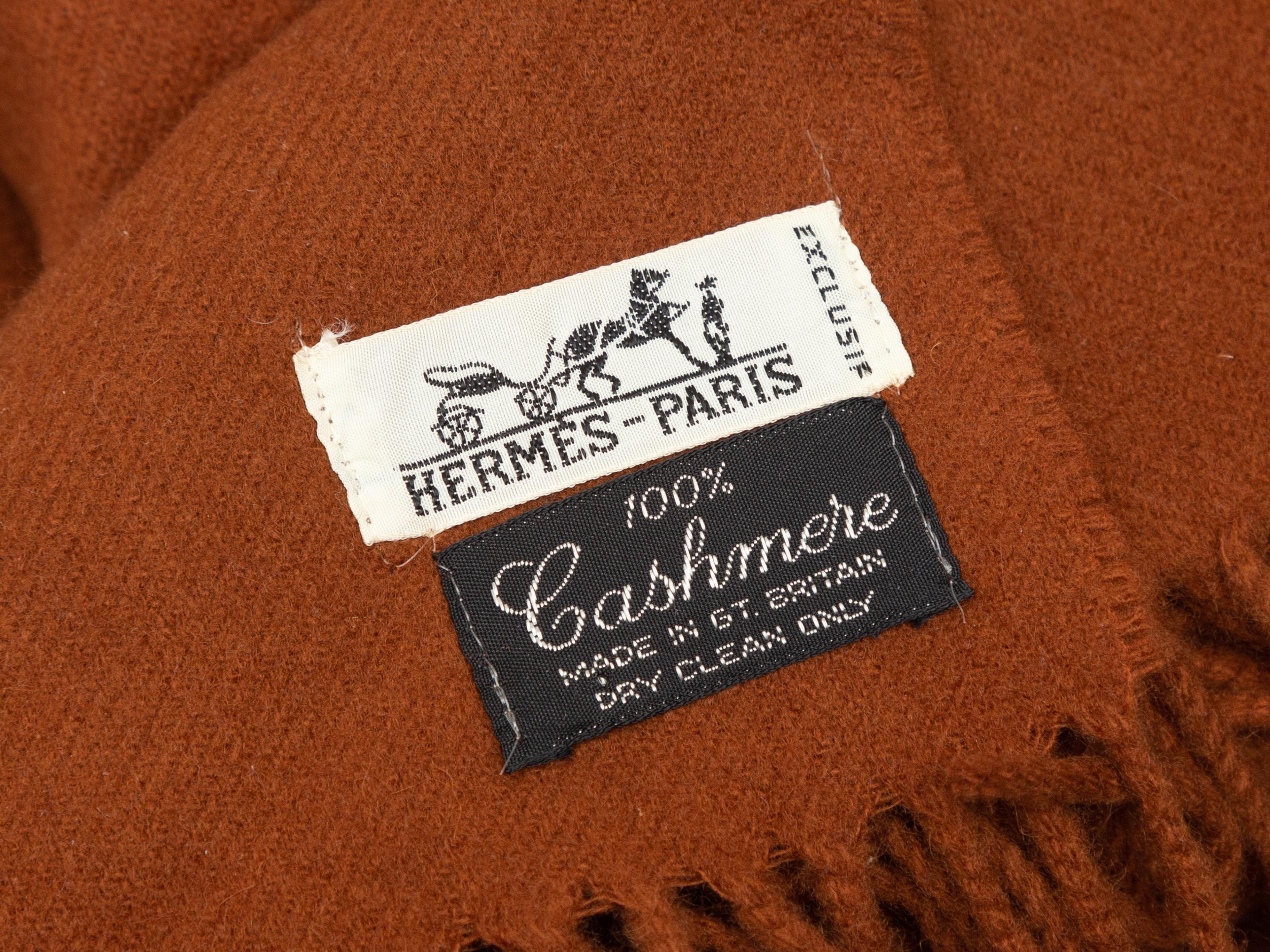 Product Details: Rust cashmere scarf by Hermes. Fringe trim at ends. 72