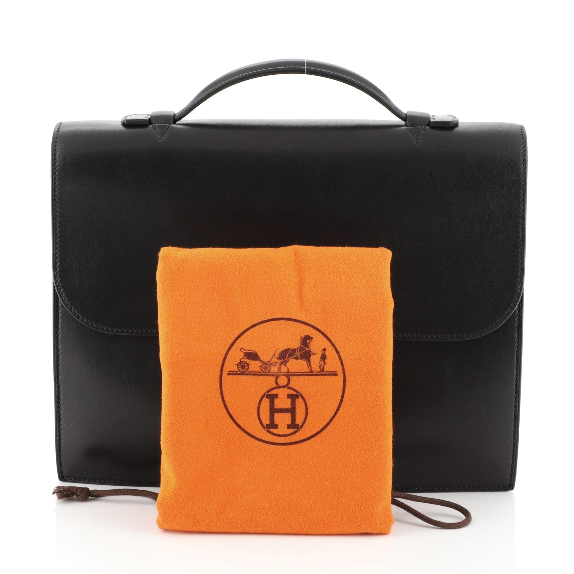 This Hermes Sac a Depeches Bag Swift 27, crafted from Noir black Swift leather, features flat top handle, accordion side gussets, and palladium hardware. Its flip-lock closure opens to a Noir black raw leather interior. Date stamp reads: I Square