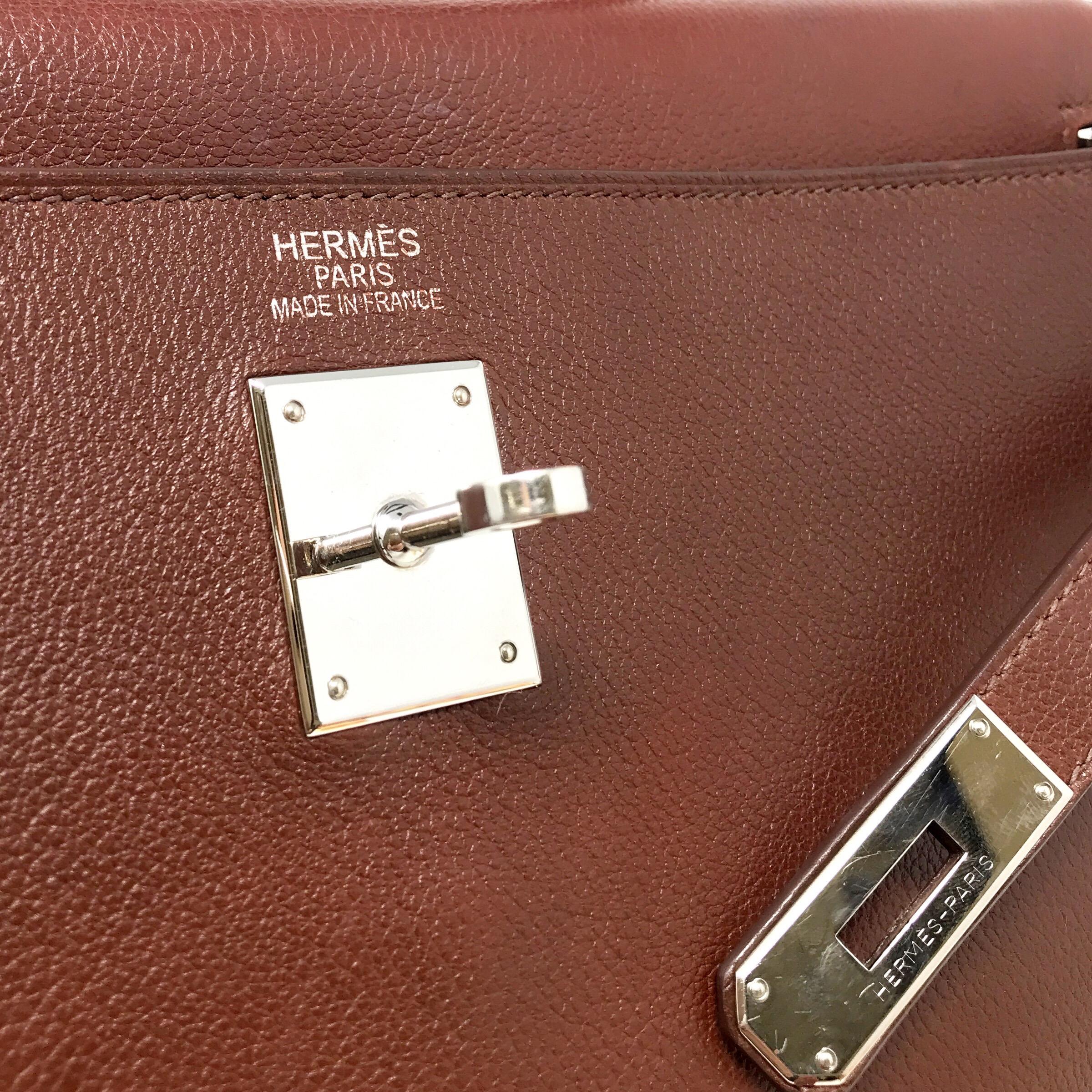 HERMES PARIS Sac KELLY Retourne, This fabulous Made from Hermes signature box leather in a deep brown color, this bag is lined in caramel colored goatskin and features brown stitching. Very Good Condition medium size 35, strap included. hdw silver.