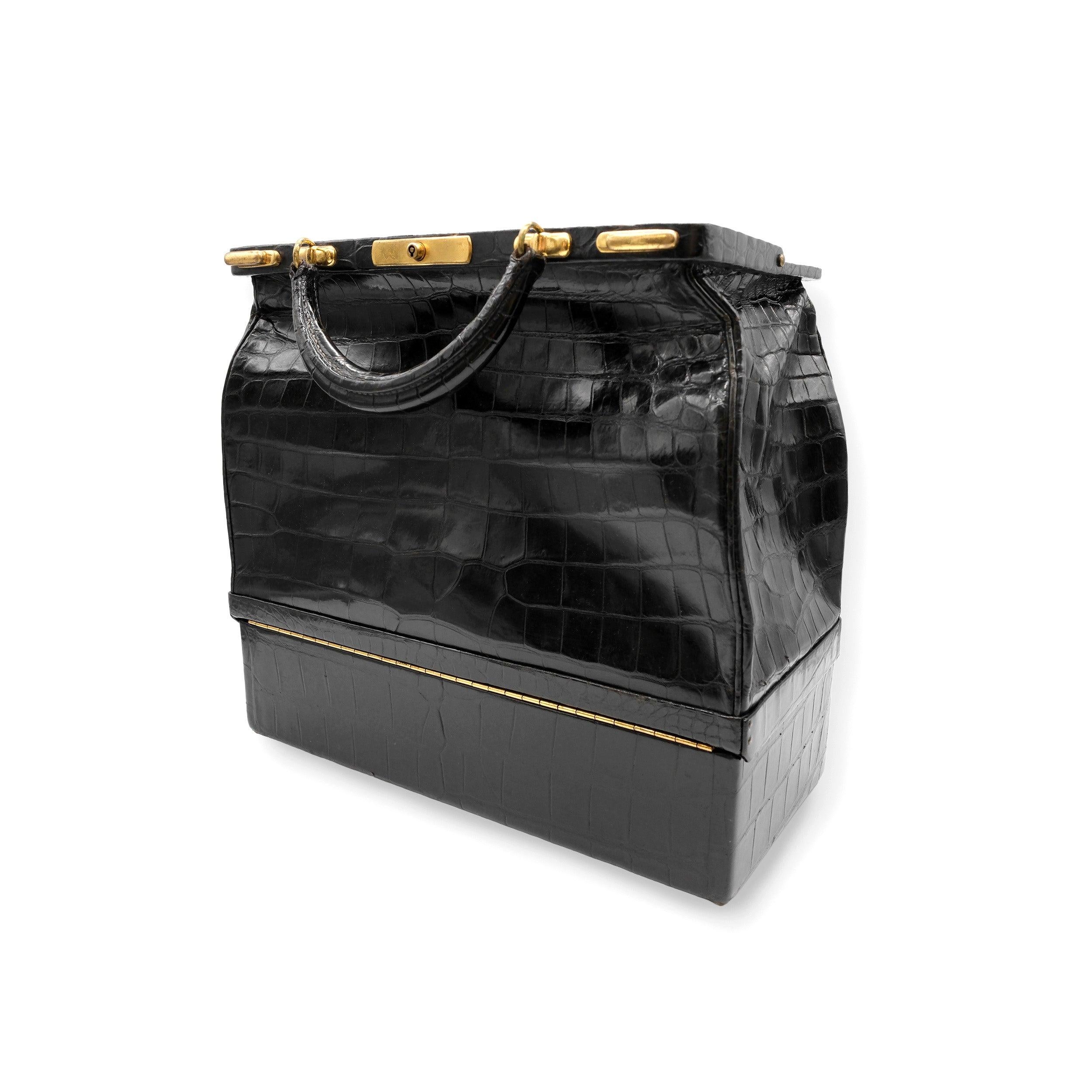 A true vintage collector's gem, the Hermès Sac Mallet is an exceptional way to bring the heritage of Hermès into any collection. Crafted from luxurious, shiny black crocodile leather, this bag showcases the craftsmanship and skill of Hermès