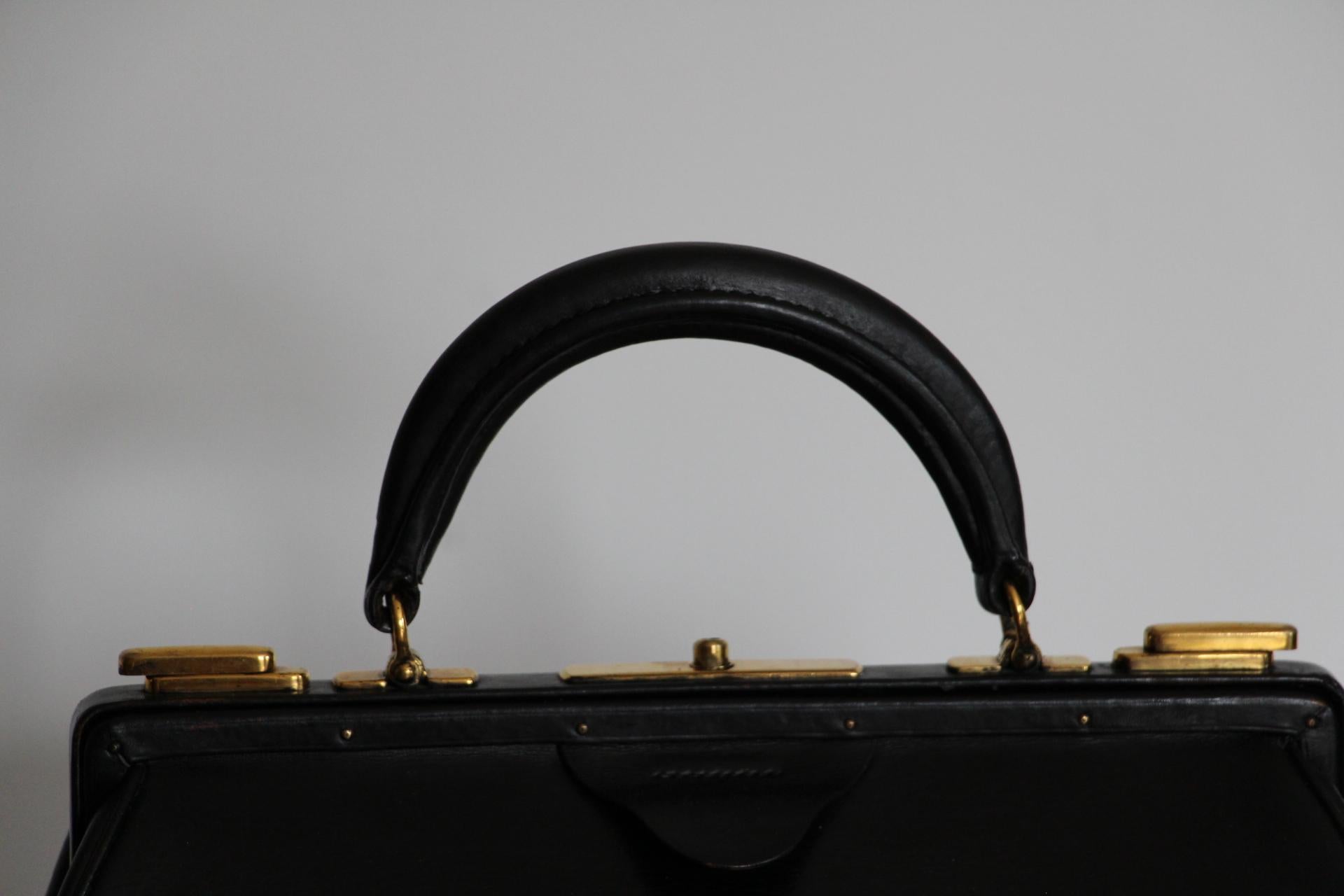 Hermes Vintage Sac Mallette was originally designed in the 1920's .Very unusual, this exceptionally stunning piece is a must have for all Hermes collectors. It features beautiful, rich black box calf leather. Warm gold tone push locks and clasps