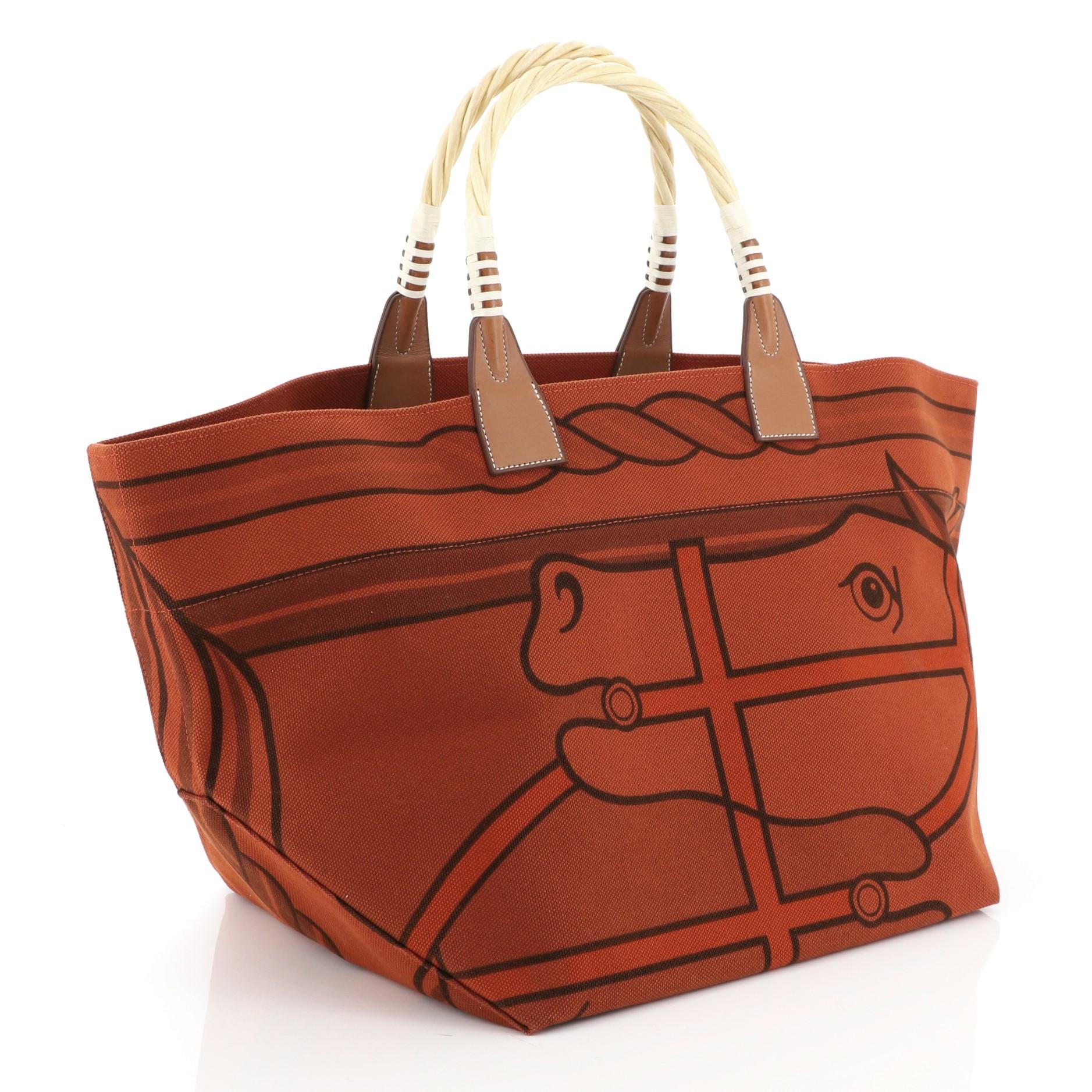 This Hermes Sac Steeple Tote Printed Toile with Wood, crafted from Brique Toile H and Fauve Barenia leather, features a graphic print design and dual wood top handles. It opens to a Brique Toile H interior. Date stamp reads: P Square (2012).