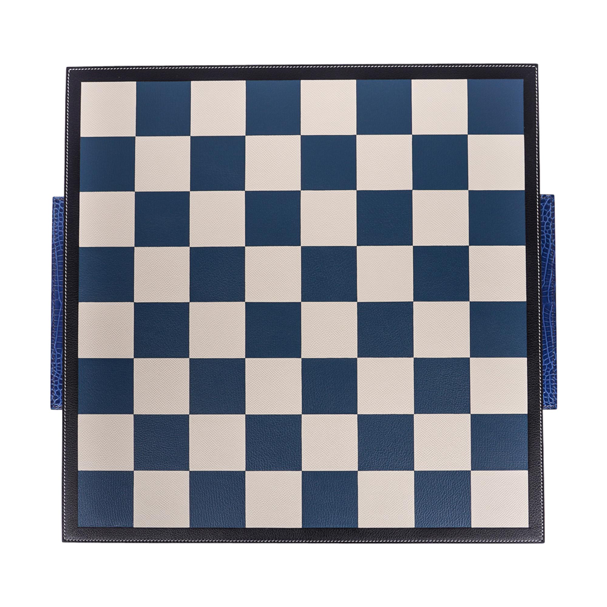 Mightychic offers an Hermes Samarcande Chess Set.
Composed of Natural Sycamore and Mahogany wood.
Beautiful contrasting wood pieces.
Gorgeous Bleu Electric Crocodile handles.
Leather covered board in Blue and cream.
Fabulous for game night parties