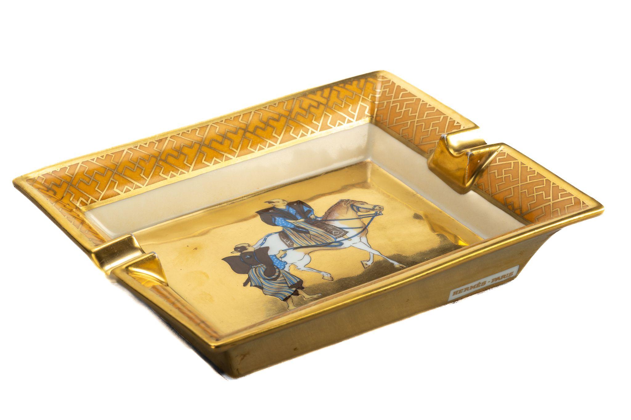 Hermes signature ashtray with samurai design in yellow  and gold. Suede stamped bottom. Minor wear on it. Made in France. Original box.