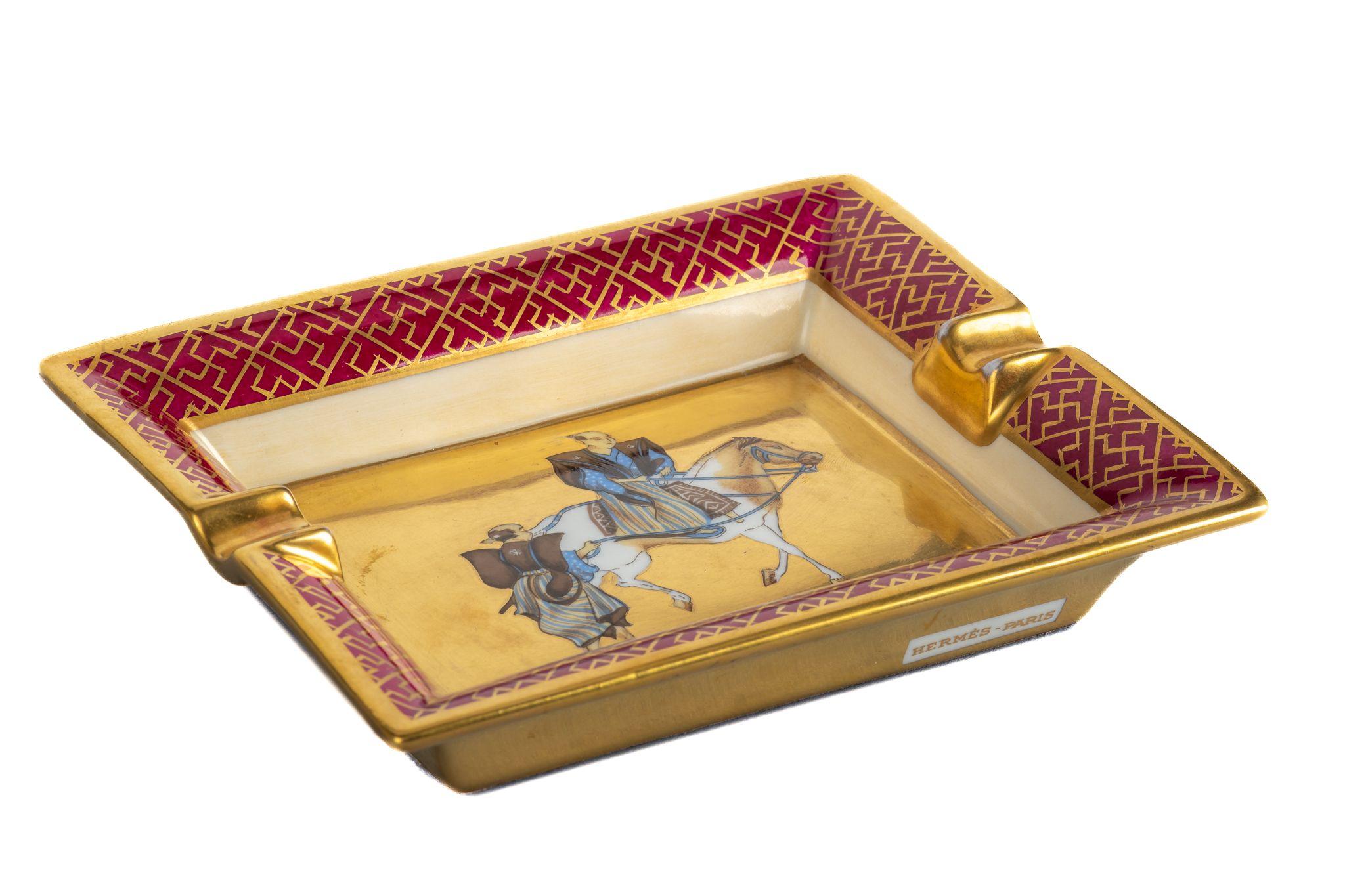 Hermes signature ashtray with samurai design in red and gold. Suede stamped bottom. Minor wear on it. Made in France.