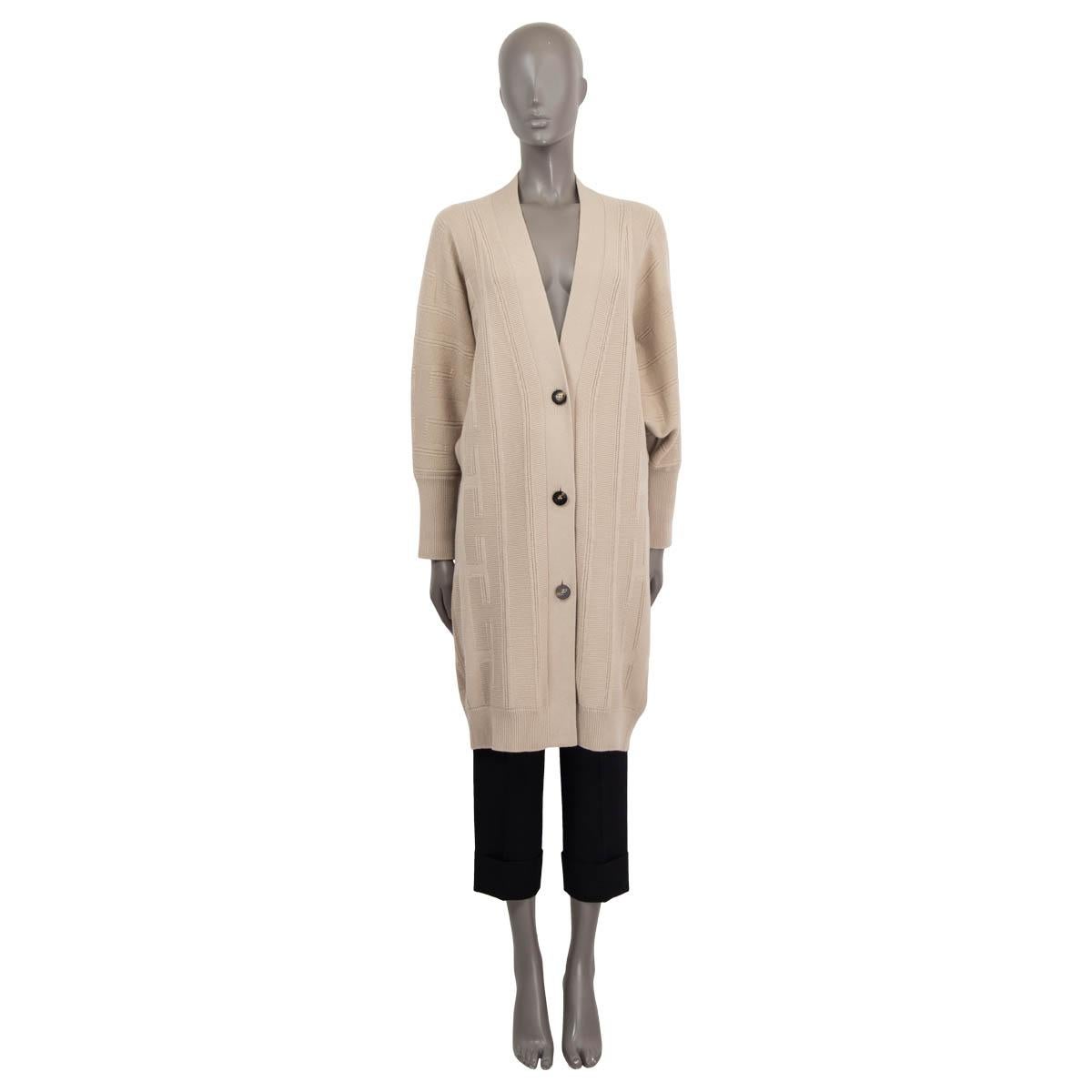 100% authentic Hermès Pre-Fall 2020 voyage long oversized knit coat in sand wool (100%). Features long raglan sleeves (sleeve measurements taken from the neck) and a deep v-neck. Opens with three buttons at the front. Unlined. Has been worn once and