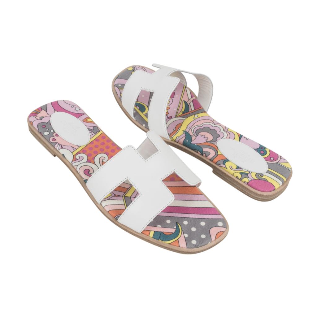 Guaranteed authentic Hermes Oran flar sandal feaured in White leather.
The iconic top stitched H cutout over the top of the foot.
Scarf print silk insole. 
Natural wood heel with leather sole. 
Comes with sleepers and signature Hermes box. 
NEW or