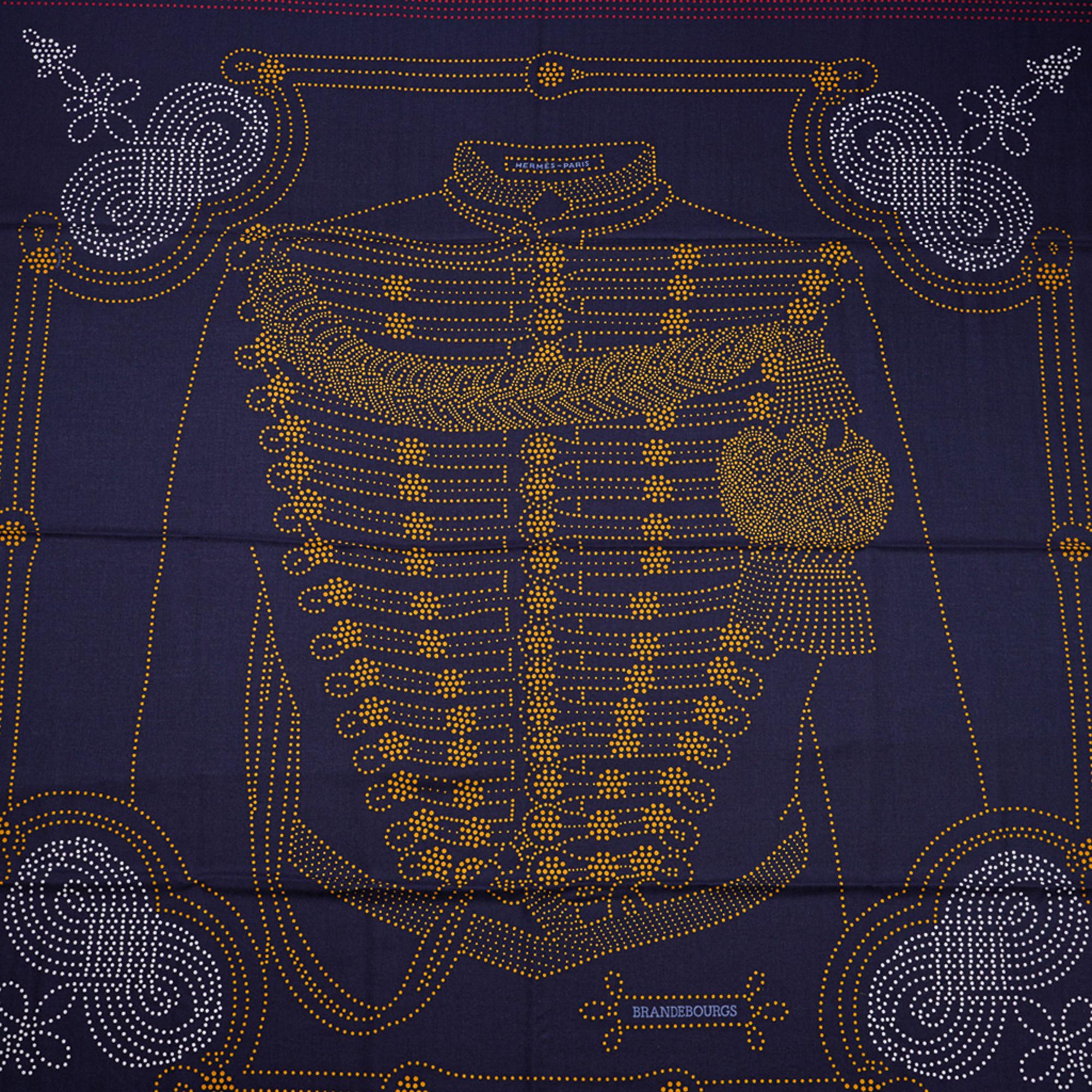 Mightychic offers an Hermes Brandebourgs Points Cashmere and Silk shawl.
Inspired by the uniforms of the Second Empire Imperial Guard.
Designed by Caty Latham.
Exquisite in Bleu Noir, Gold and Rouge.
Signature hand rolled edge.
Comes with Signature