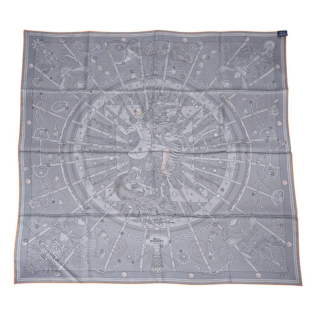 Guaranteed authentic Hermes C'est La Fete Double Face Silk Twill scarf by Daiske Nomura.  
In shades of grey and dark green, with a border of grey, olive and mustard.
Features a skeleton riding a skeleton horse amid a burst of stars.
A large subtle