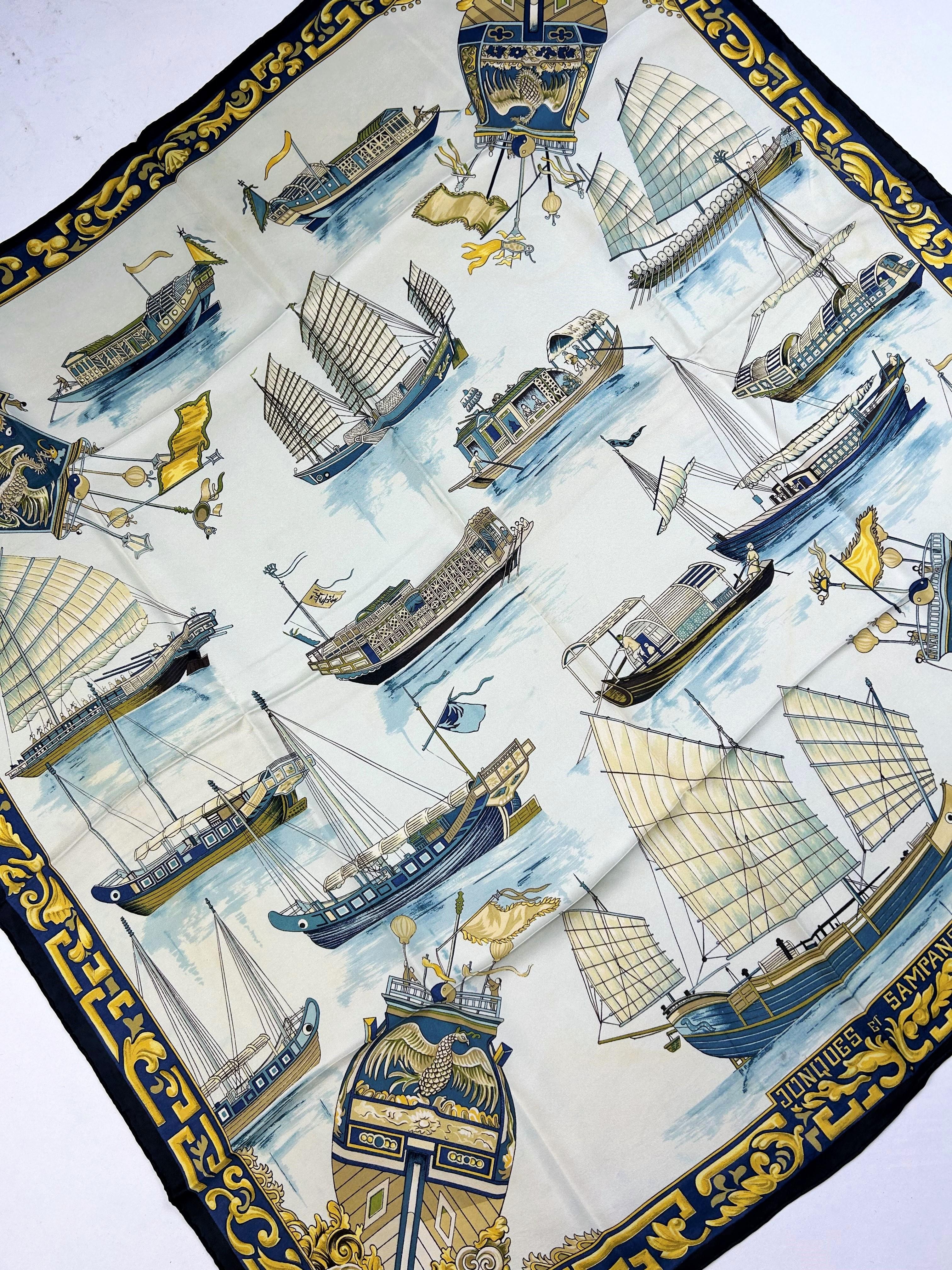 Circa 1966
France 

A Vintage Hermès silk Scarf entitled Jonques et Sampans in silk twill printed in shades of blue and golden yellow. This is most likely the first edition of a design by Françoise de la Perrière dating from 1966. A second, later