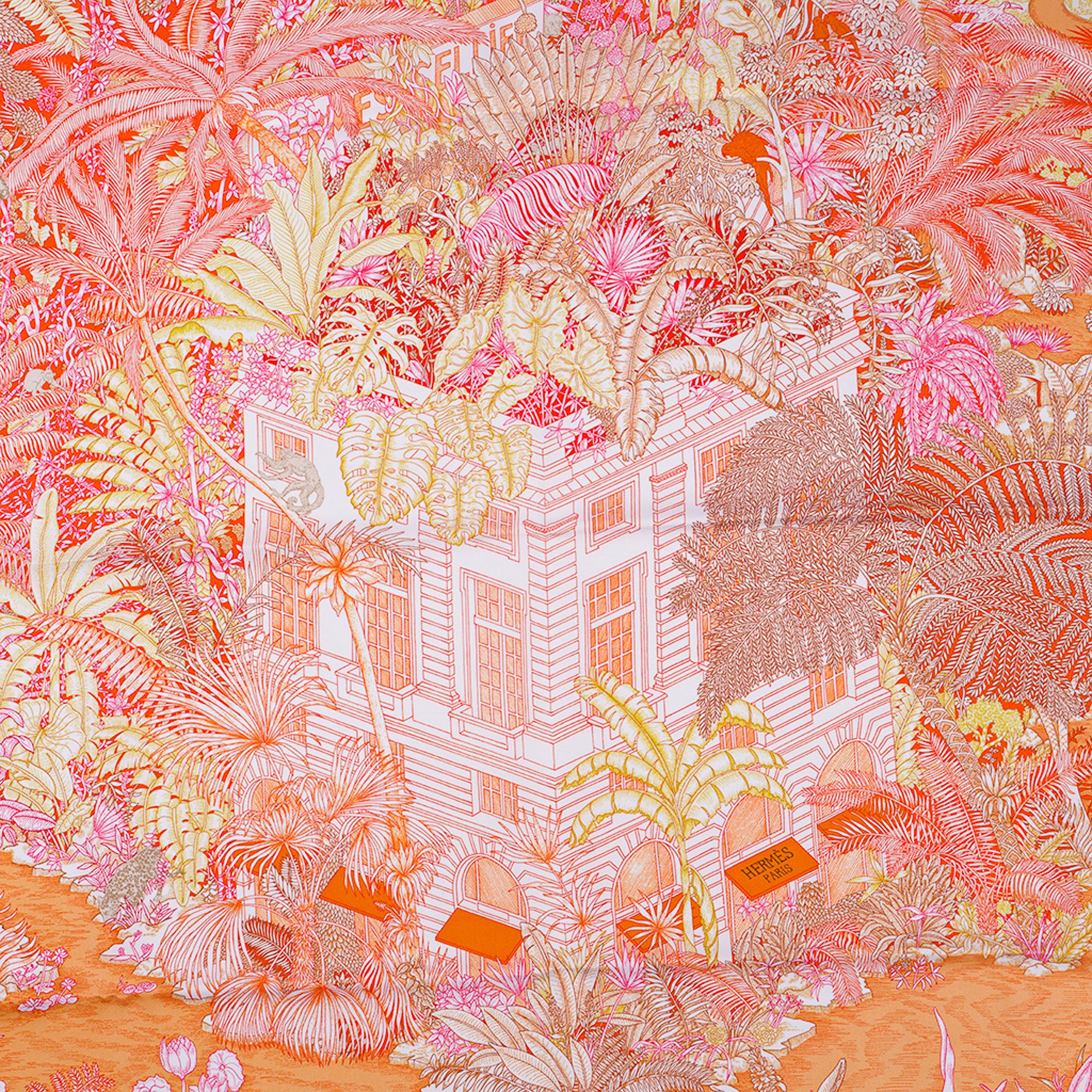 Mightychic offers a guaranteed authentic Hermes Faubourg Tropical scarf featured in Orange, Mangue and Rose.
Designed by Octave Marsal and Theo de Gueltzl.
This Hermes 90 silk scarf is set with a wonderful tropical jungle filled with marvelous