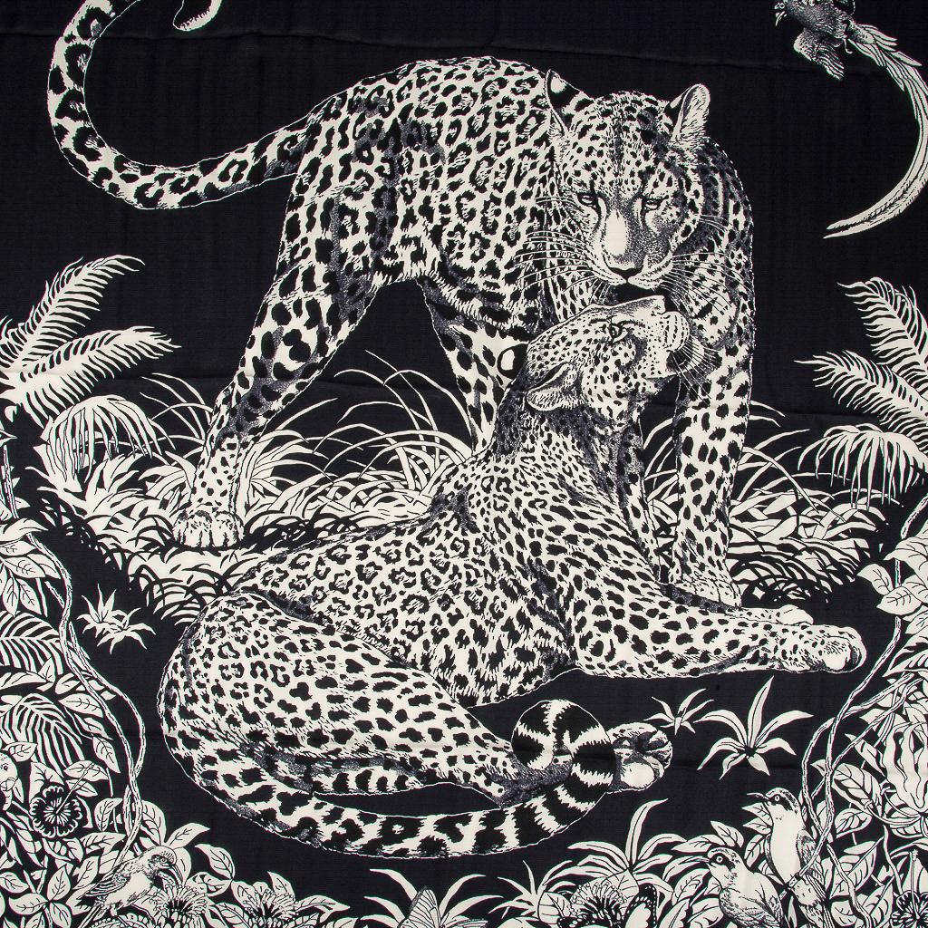 Guaranteed authentic Hermes iconic Jungle Love Tattoo Cashmere and Silk beauty features Bleu Noir and Blanc.  
This picture of love depicts 2 amorous leopards in their natural habitat.
Designed by Robert Dallet who worked as a naturalist for the