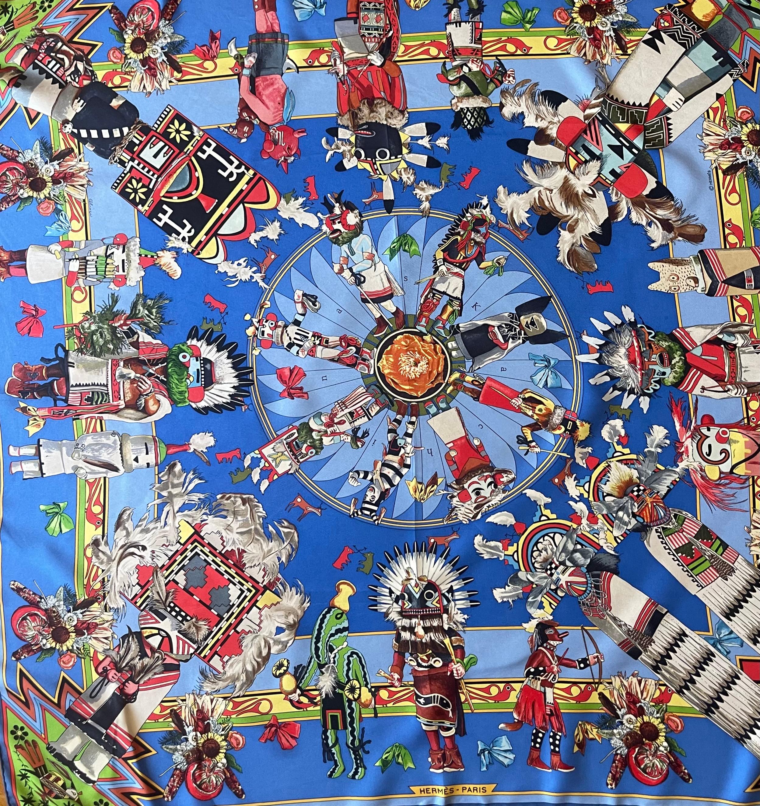 Le foulard Hermès Kachinas, conçu par l'artiste américain Kermit Oliver en 1992, est une pièce emblématique rendant hommage à la culture des peuples autochtones du sud-ouest des États-Unis.
In good condition. 
35in x 35in. 