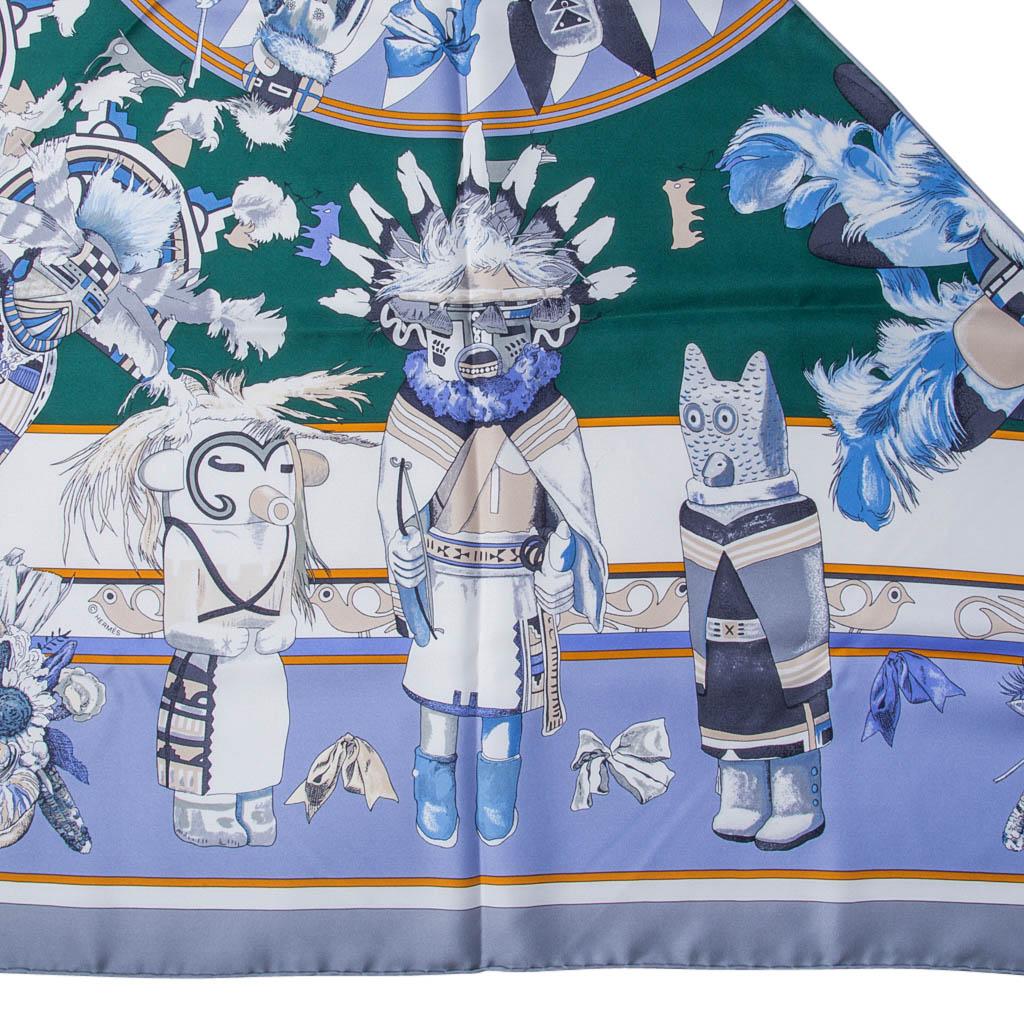 Guaranteed authentic Hermes Kachinas Giant Triangle Silk Twill scarf by Kermit Oliver.  
Vert, Mauve and Gris colorway.
Depicts ritual dolls given to Hopi children.
With their peace loving nature, they are on good terms with the spirits. 
From the