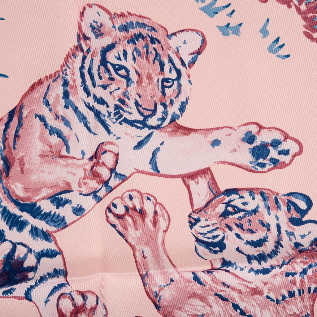 Guaranteed authentic Hermes Les Tigreaux 45 silk scarf. 
Features playful Leopard cubs at play designed by Robert Dallet.
Beautiful in Rose Pale and Blue, this delightful scarf can accent your wardrobe and bags in a myriad ways!
Comes with signature