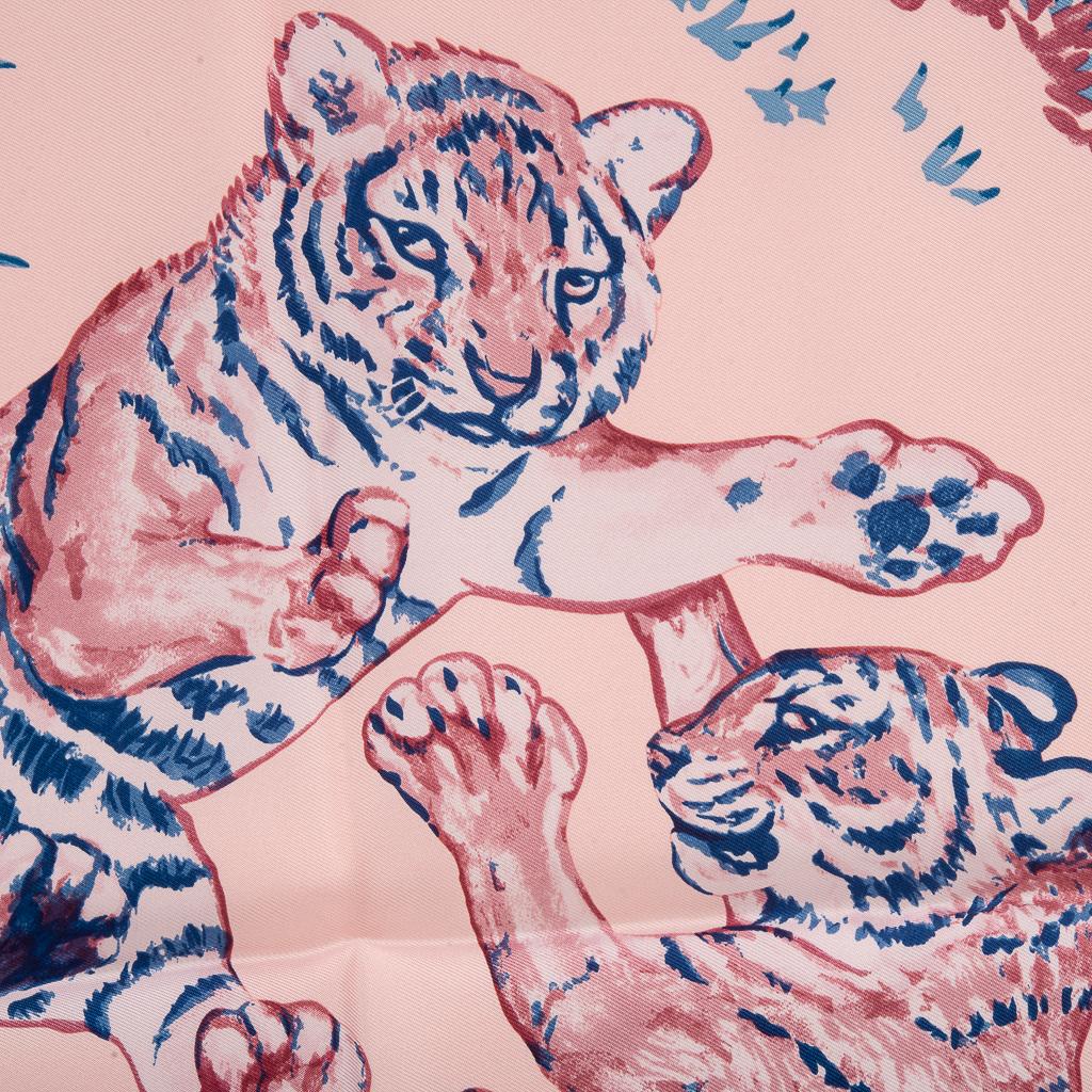 Guaranteed authentic Hermes Les Tigreaux 45 silk scarf. 
Features playful Leopard cubs at play designed by Robert Dallet.
Beautiful in Rose Pale and Blue, this delightful scarf can accent your wardrobe and bags in a myriad ways!
Comes with signature