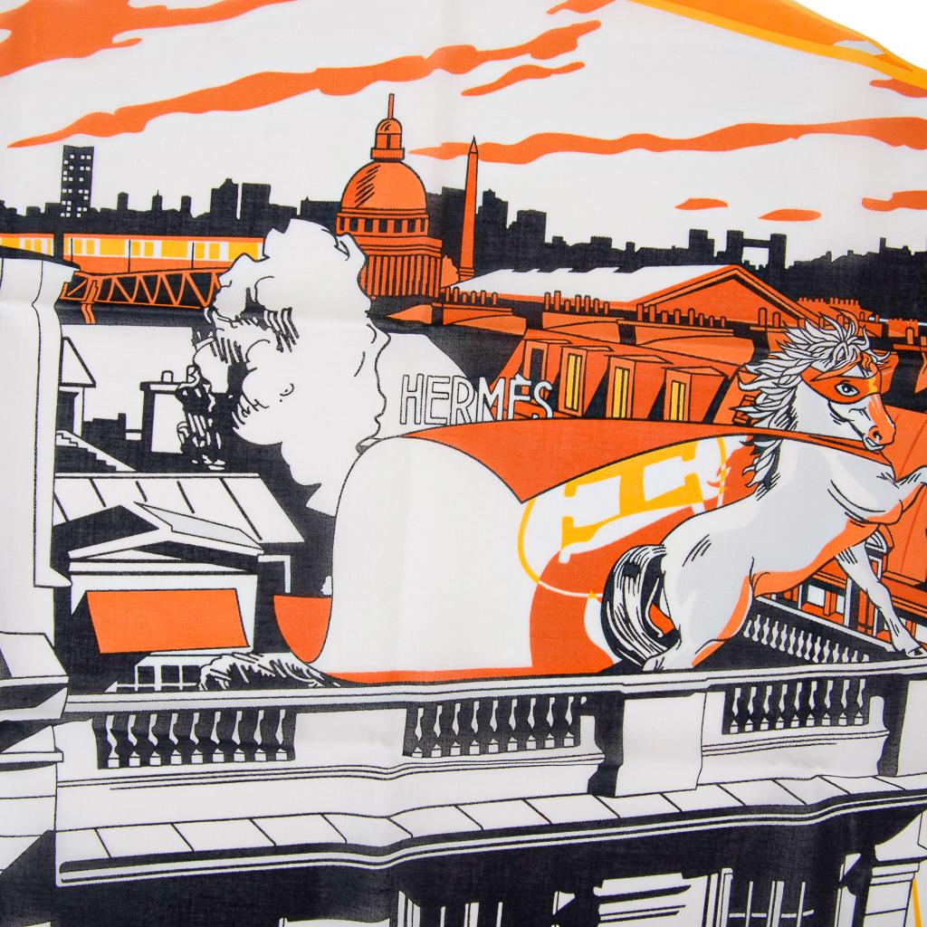 Guaranteed authentic Hermes Minuit au Faubourg cotton handkerchief.  
Reminiscent of Super Hero scenes, this playful is designed in comic book style.
Super Hero caped and masked Horse on top of the Hermes Flagship store with renowned Parisian