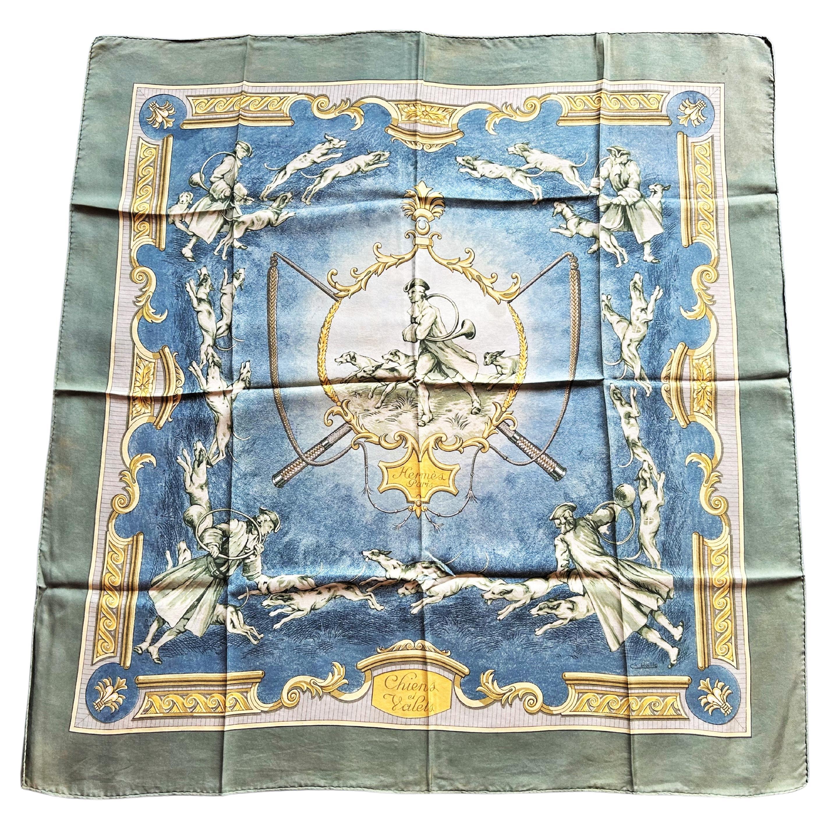 Circa 1965
France 

A Vintage Hermès silk scarf entitled Chiens et Valets in silk twill printed in shades of blue, golden yellow and greenish. This is most likely the first edition of a design by Jean-Charles Hallo dating from 1965. A second, later