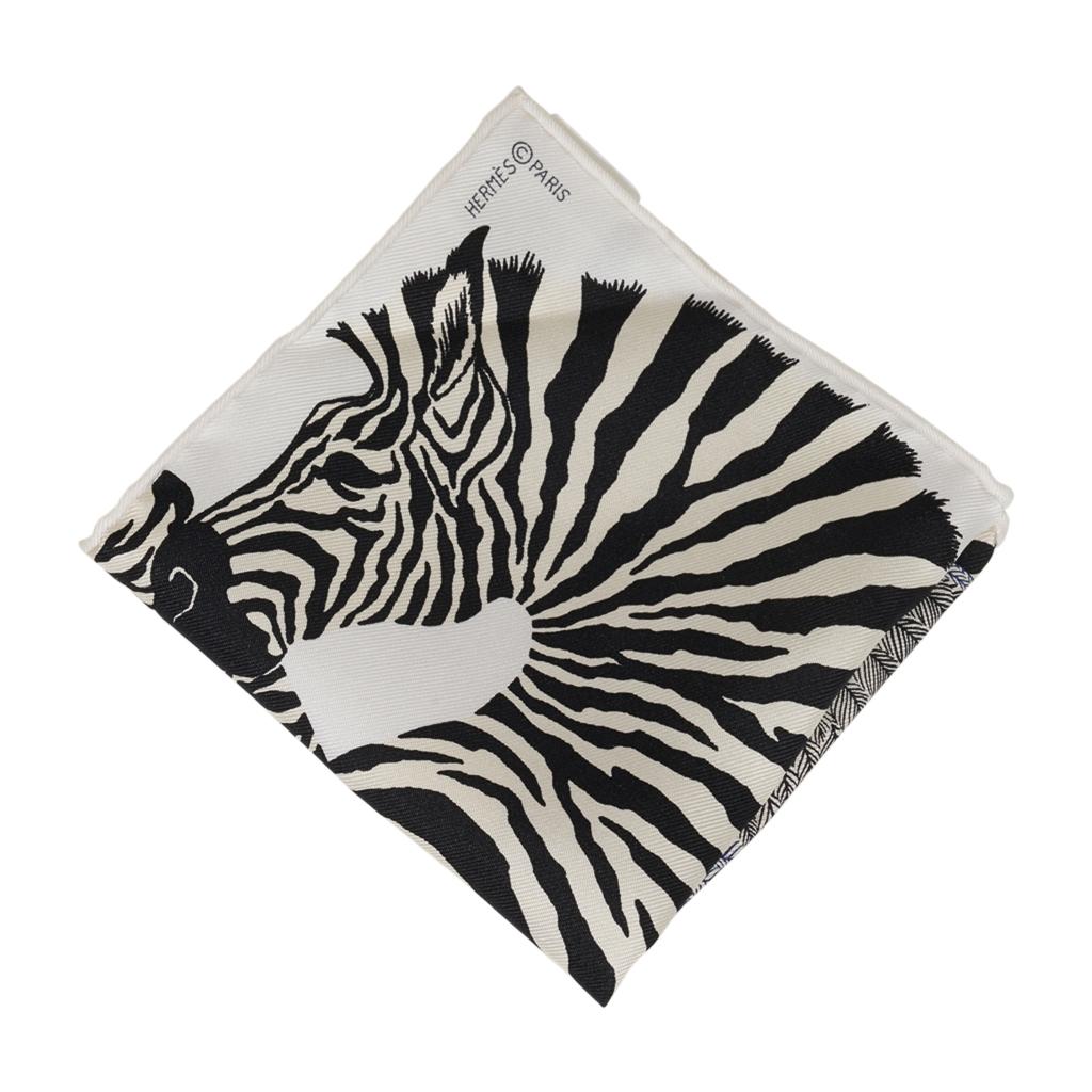 Guaranteed authentic Hermes Zebra Pegasus 20 cm Nano Scarf featured in Noir and Blanc.
This iconic Hermes accessory can be worn in a myriad ways to add a playful touch to your wardrobe.
Tucked in a pocket, worn on the wrist or ankle, tied to the