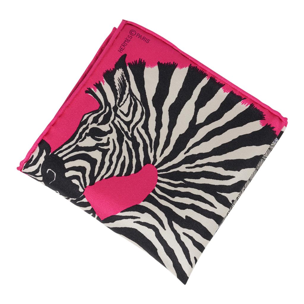 Guaranteed authentic Hermes  Zebra Pegasus 20 cm Nano Scarf featured in Rose Bonbon, Noir and Blanc.
This iconic Hermes accessory can be worn in a myriad ways to add a playful touch to your wardrobe.
Tucked in a pocket, worn on the wrist or ankle,