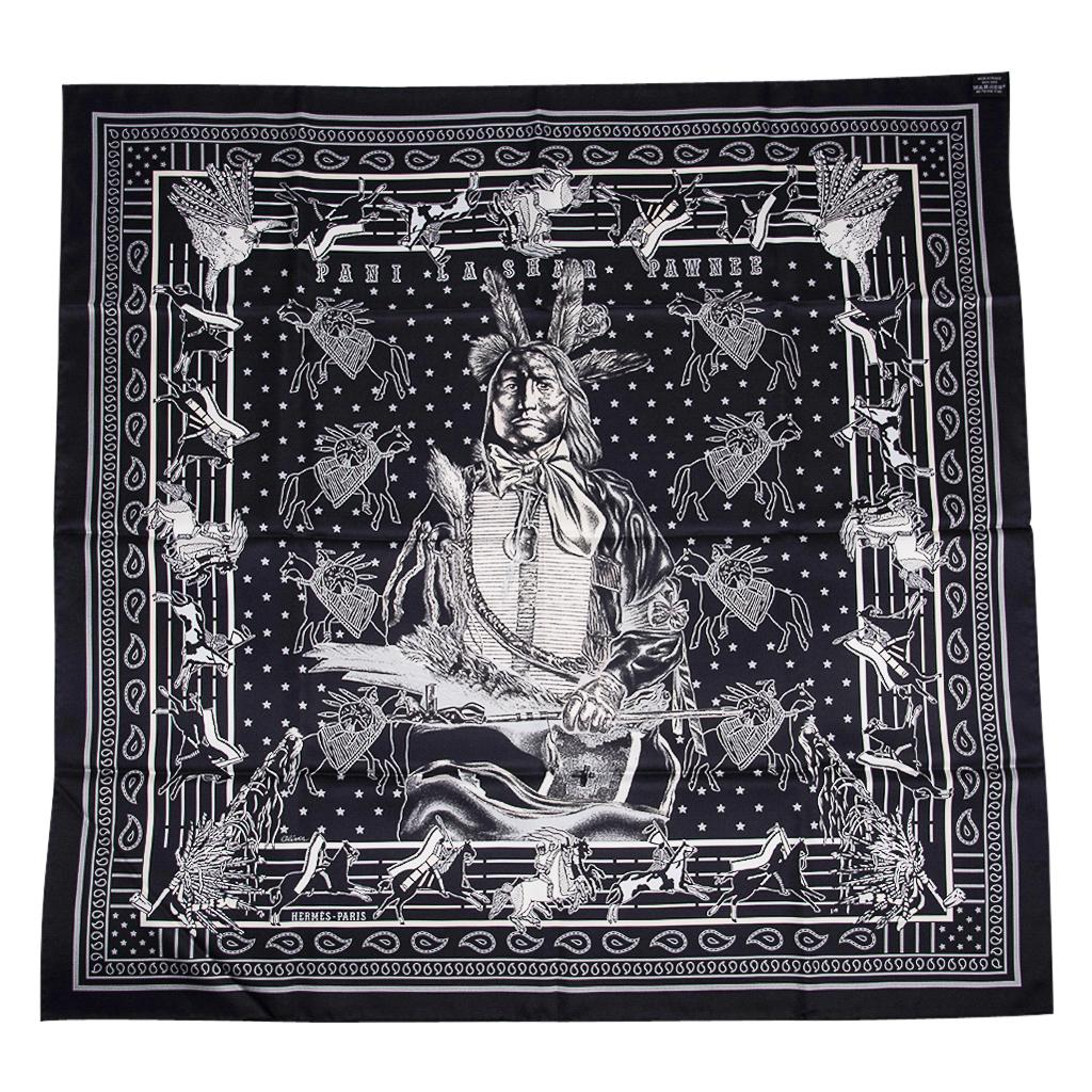 Guaranteed authentic Hermes Pani La Shar Double Face Silk Twill scarf by Kermit Oliver.  
In Noir and Marine, the scarf honors the dignity of Pani La Shar and of the Pawnee people.
He is holding a peace pipe with a sculpted galloping horse.
The