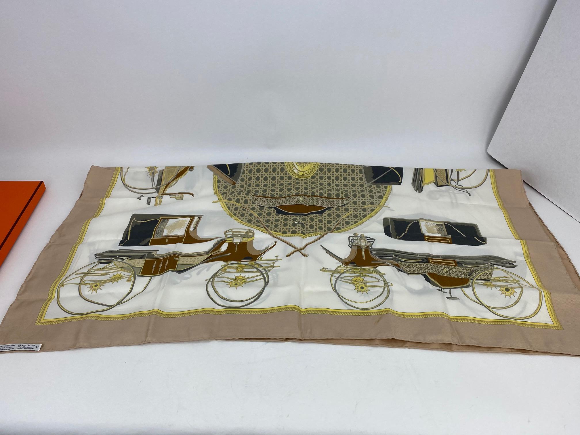 Pre-Owned 100% Authentic
Hermes Les Voitures A Transformation Silk Scarf
 RATING: B/C   good, item shows some sign of wear
MATERIAL: 100% silk
COLOR: tan, brown, olive green, yellow,
black, white 
EXTERIOR: has few minor very light marks,
on