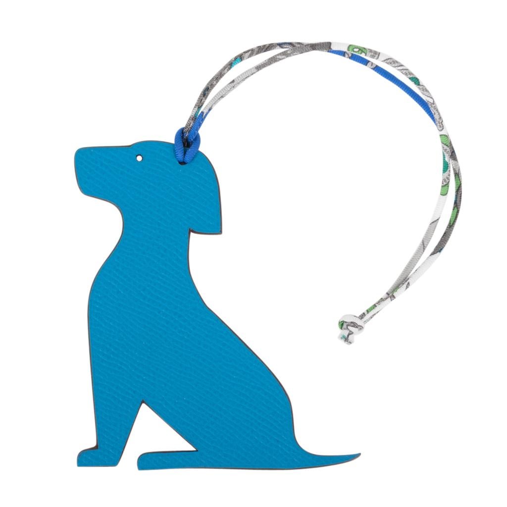 Guaranteed authentic rare Hermes bag charm features the coveted Seated Dog Petit h Bi-Color.
One side of this whimsical charm comes in Blue Epsom, the other in Trench Togo and will add a delightful touch to a myriad of your bags! 
Twill silk printed