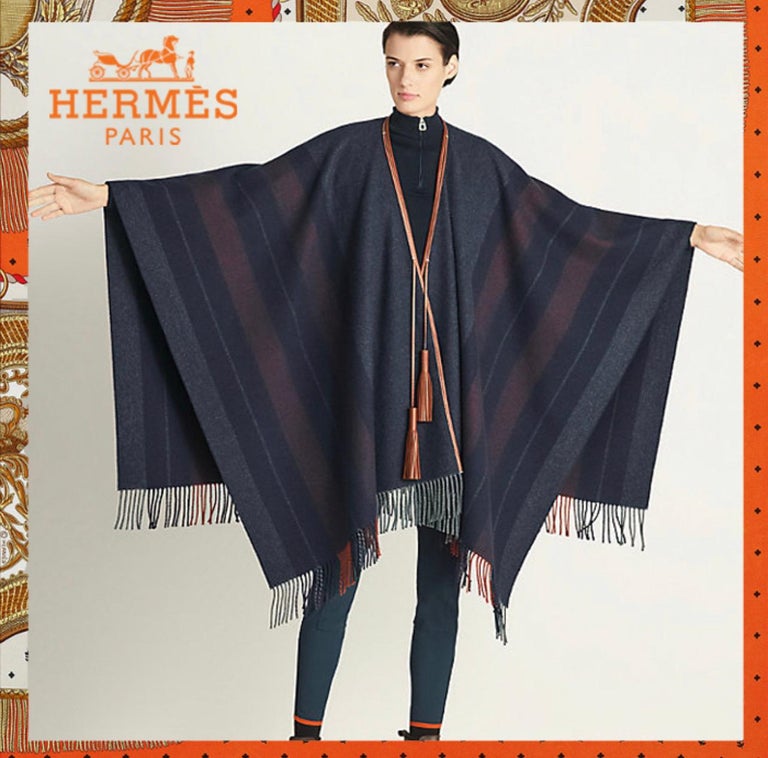 This is elegance and sophistication! Hermes has done it again! This beautifully handcrafted Hermes Sellier poncho is made out of a lux Merino Wool and Cashmere that is ultra-soft to the touch. When you go to walk out of the house on a chilly day