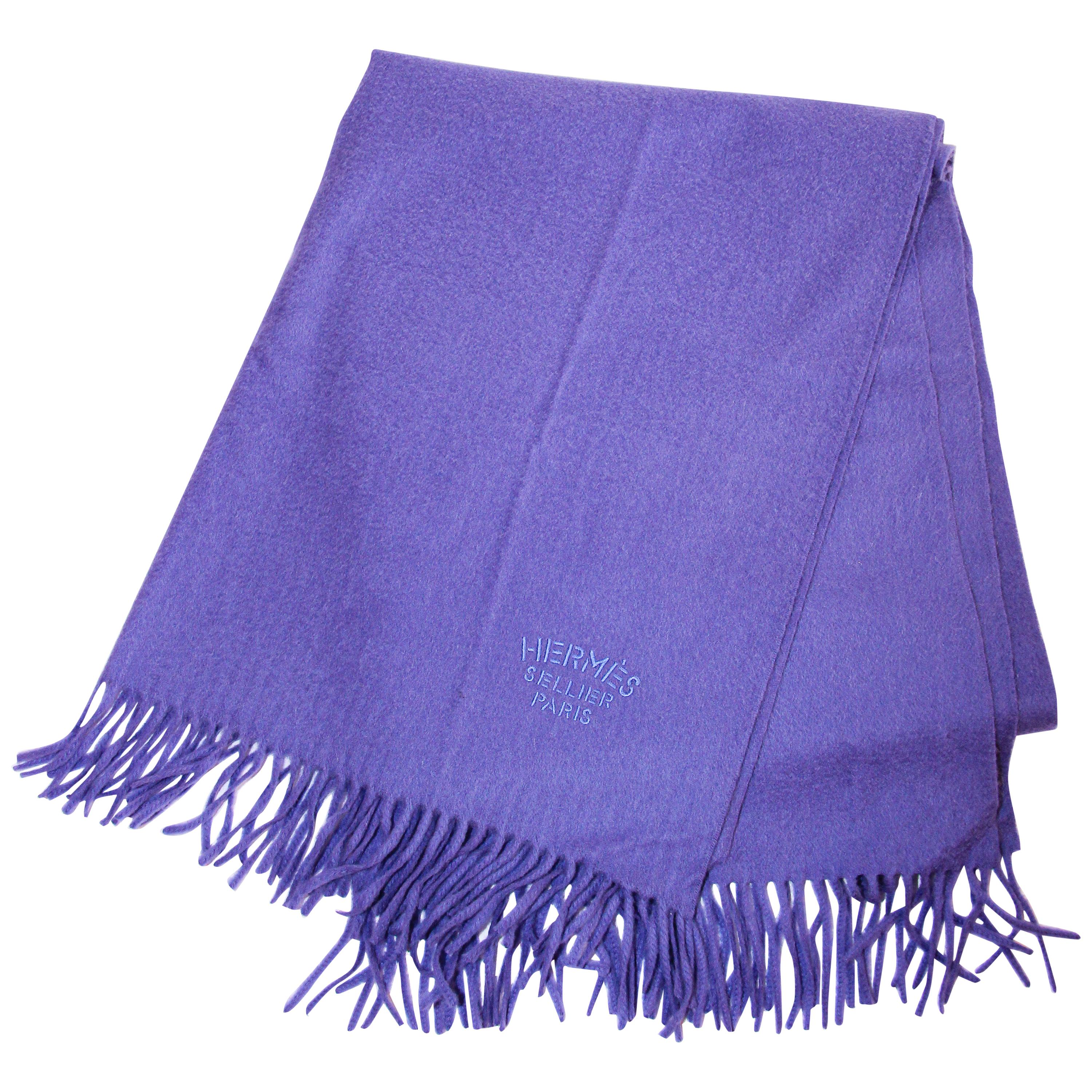 Hermès Sellier Paris embroidered iris cashmere fringe stole shawl wrap.
Authentic Hermès fringed cashmere stole embroidered Hermès Sellier Paris on one corner; fringe trim on each end. 
Large Hermès fringed cashmere shawl in iris, lavender