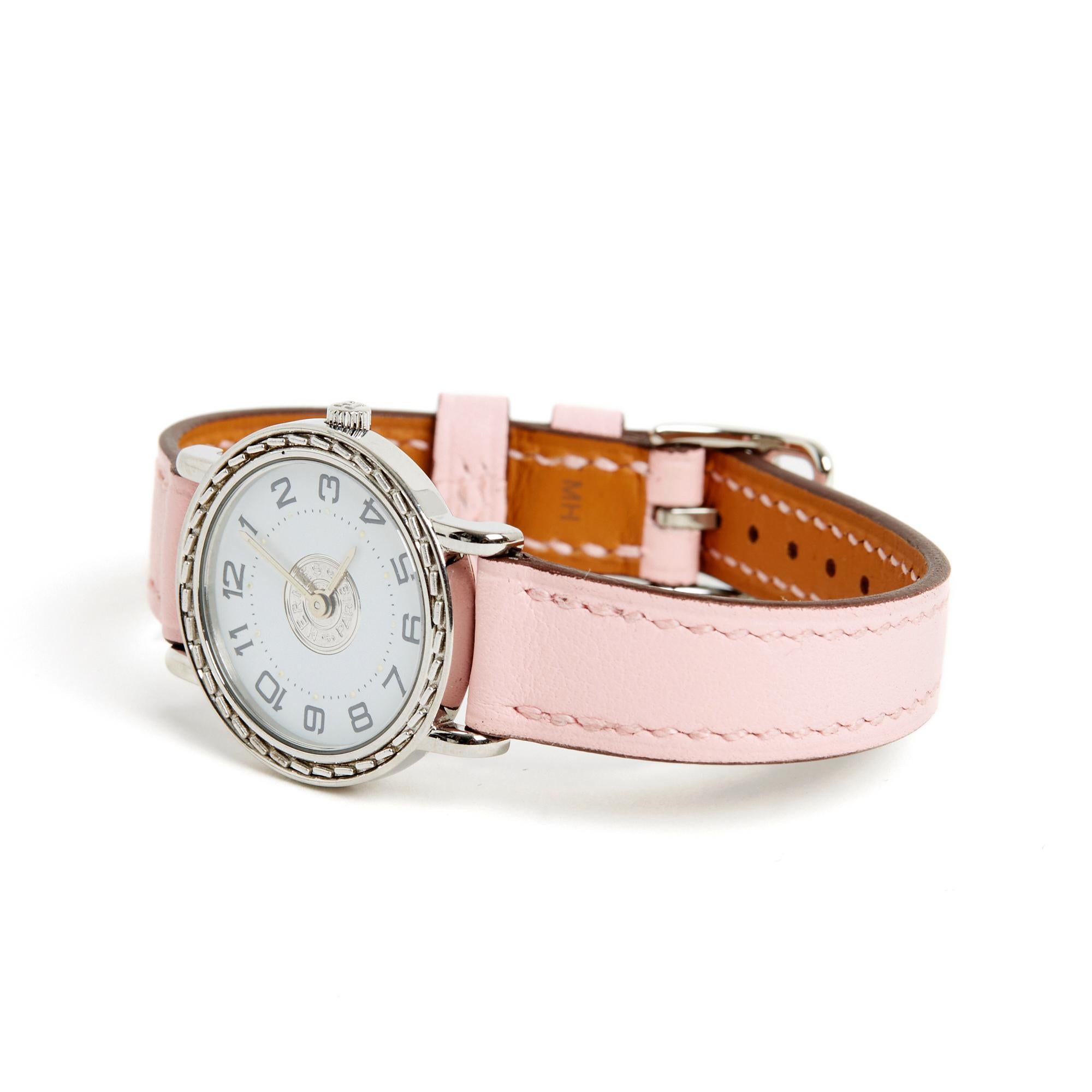 Hermès model Sellier PM format watch in steel, quartz movement, white dial with Arabic numerals, pale pink leather strap (