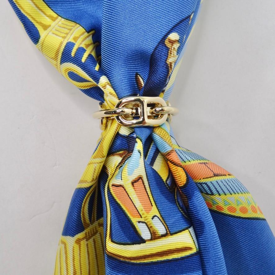 Calling all silk scarf collectors! This Hermes scarf ring is going to become your next go- to accessory! Take a look at this gorgeous Hermes Shane D'ancle Regate Scarf Ring  in a shiny yellow plated gold. This is the perfect pop of elegance to add