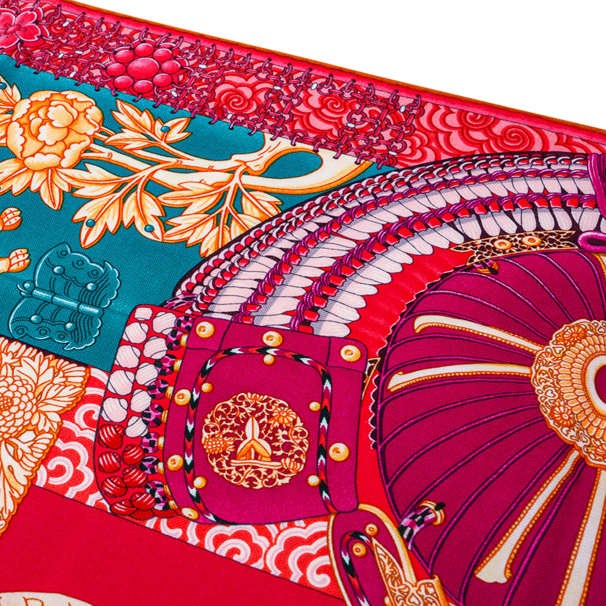 Guaranteed authentic Hermes Cashmere Silk 140 cm GM shawl Parures de Samouraïs.
Exquisite composition designed by Aline Honore features a suit of armour and floral motifs.
Vivid tones in vert, corail, and rose indien.
The samurai warriors of